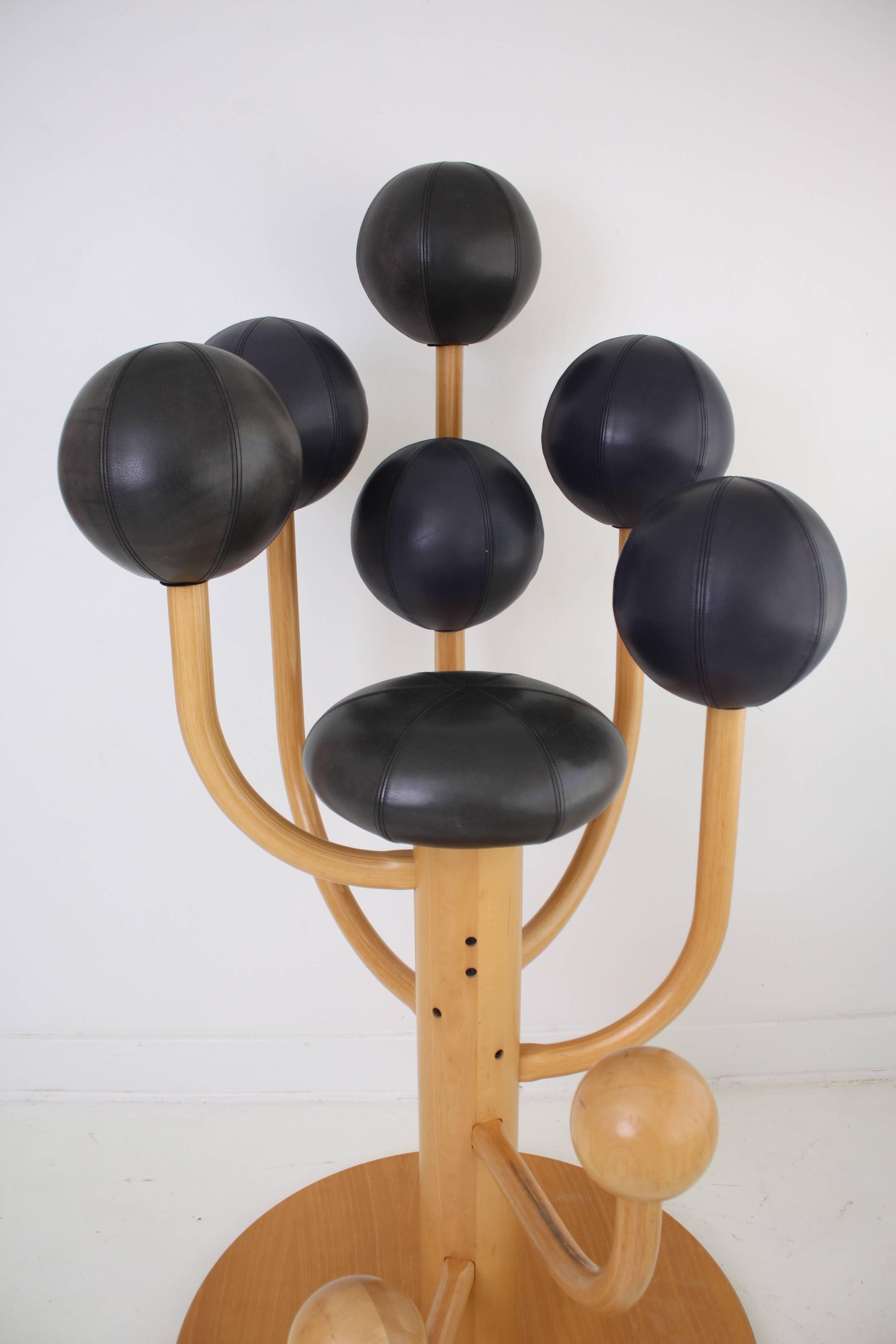 Large throne like chair. Designed to emulate sitting in a tree full of fruit, a very convivial sitting experience. Cushions are upholstered in a black and blue/black leather.