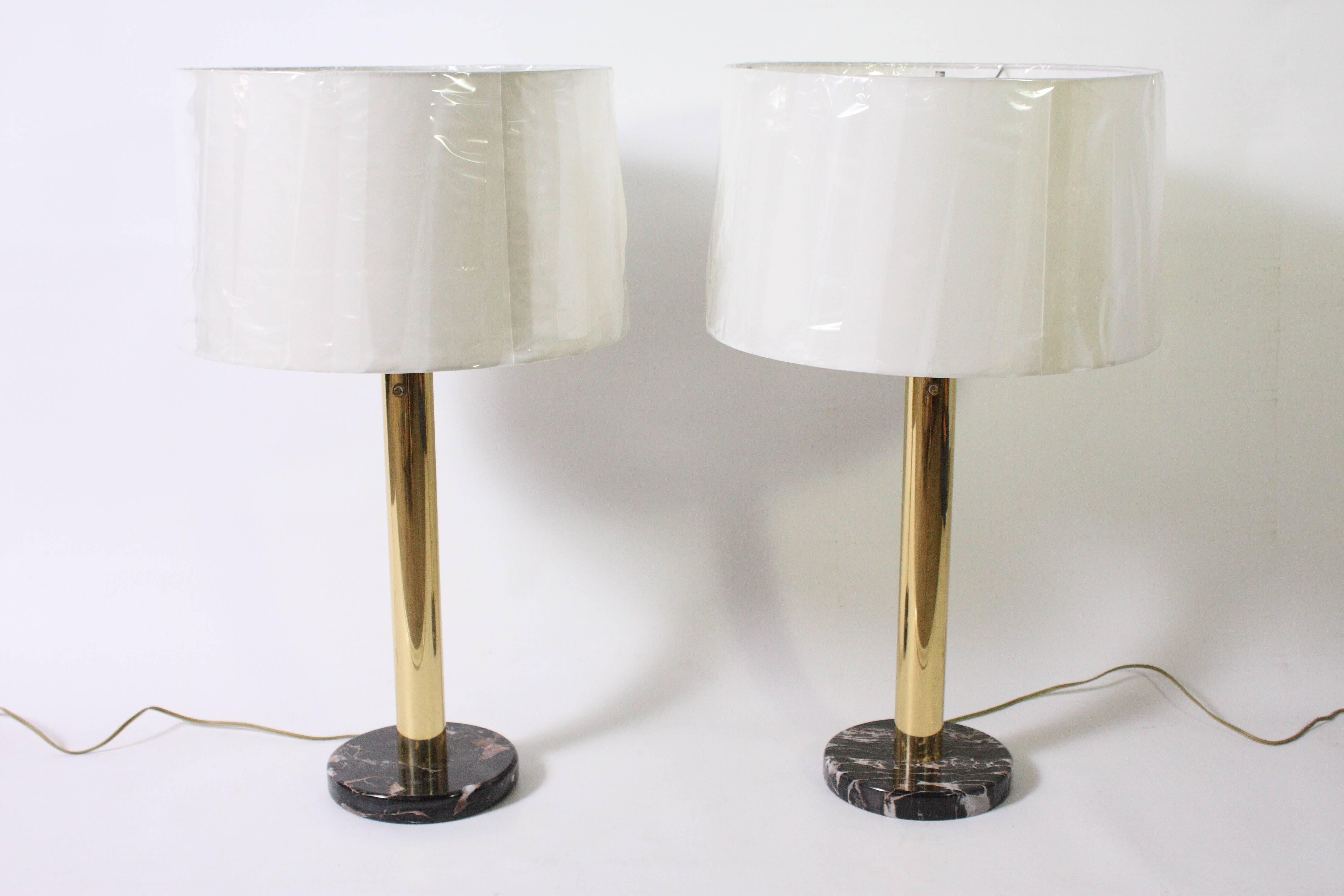 Gorgeous pair of brass and dark marble table lamps by Nessen Lighting. (shades not included). From the curated collection Space 20th Century Modern.