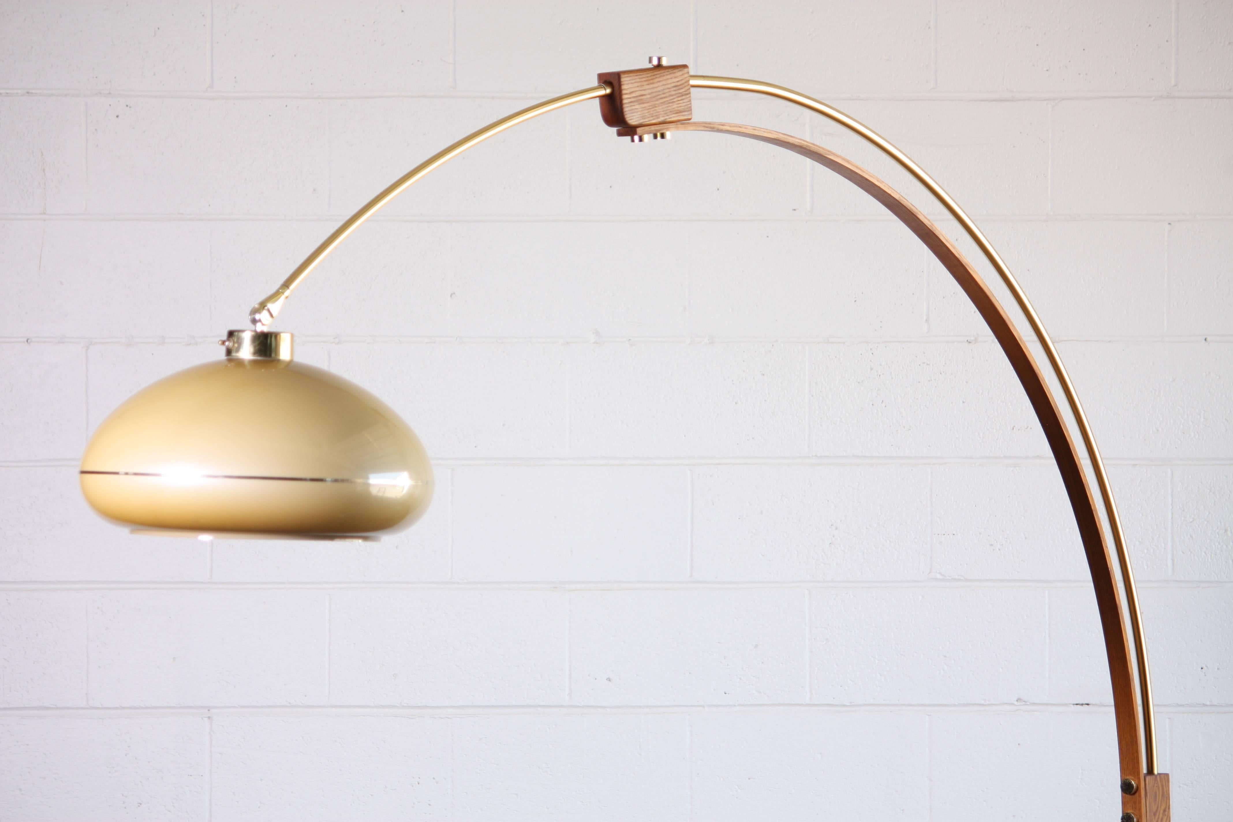 Amazing arc floor lamp constructed of brass tubing and solid wood. The shade is a wonderful creamy opaque plastic. This lamp has centre height of just over 7ft. Making it a perfect fit to reach over a sofa and into the middle of the party.