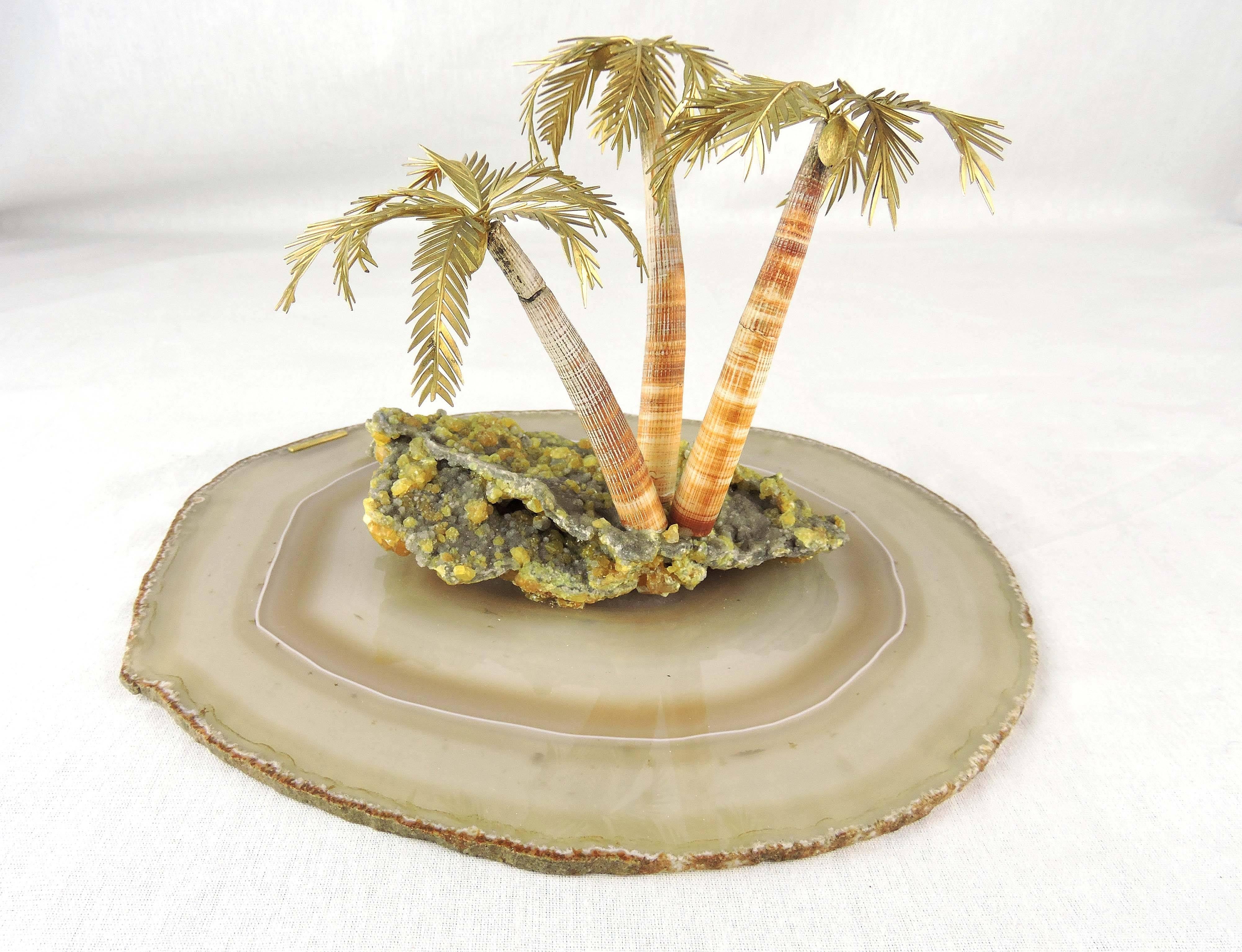This exquisite and whimsical tropical paradise is a creation of the internationally celebrated Anglo-Italian jeweller, Andrew Grima.

The island consists of three coconut palms with 18-karat gold fruit and foliage weighing approximately 2.5 oz