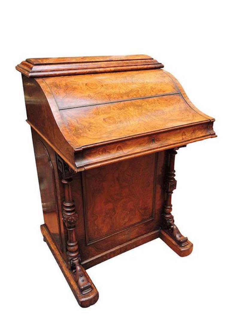 A beautiful burled walnut Harlequin Davenport desk having a desk that extends and a hidden compartment that raises up at the rear after pressing a button. The back compartment is counterbalanced and when released, raises on its own.

The desk has