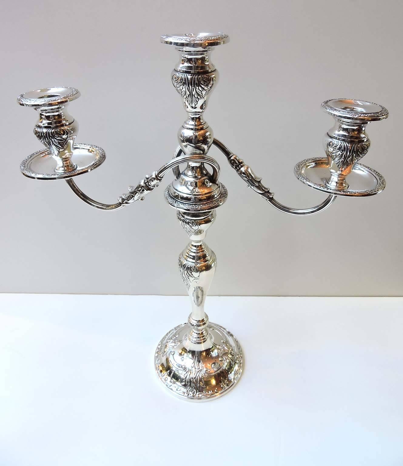 A large 17 inch pair of sterling silver candelabras by Frank M Whiting Company of Massachusetts. Each candelabra having three arms which are removable and become single candle holders. 

Marked on base of each Sterling with Whiting marks and 