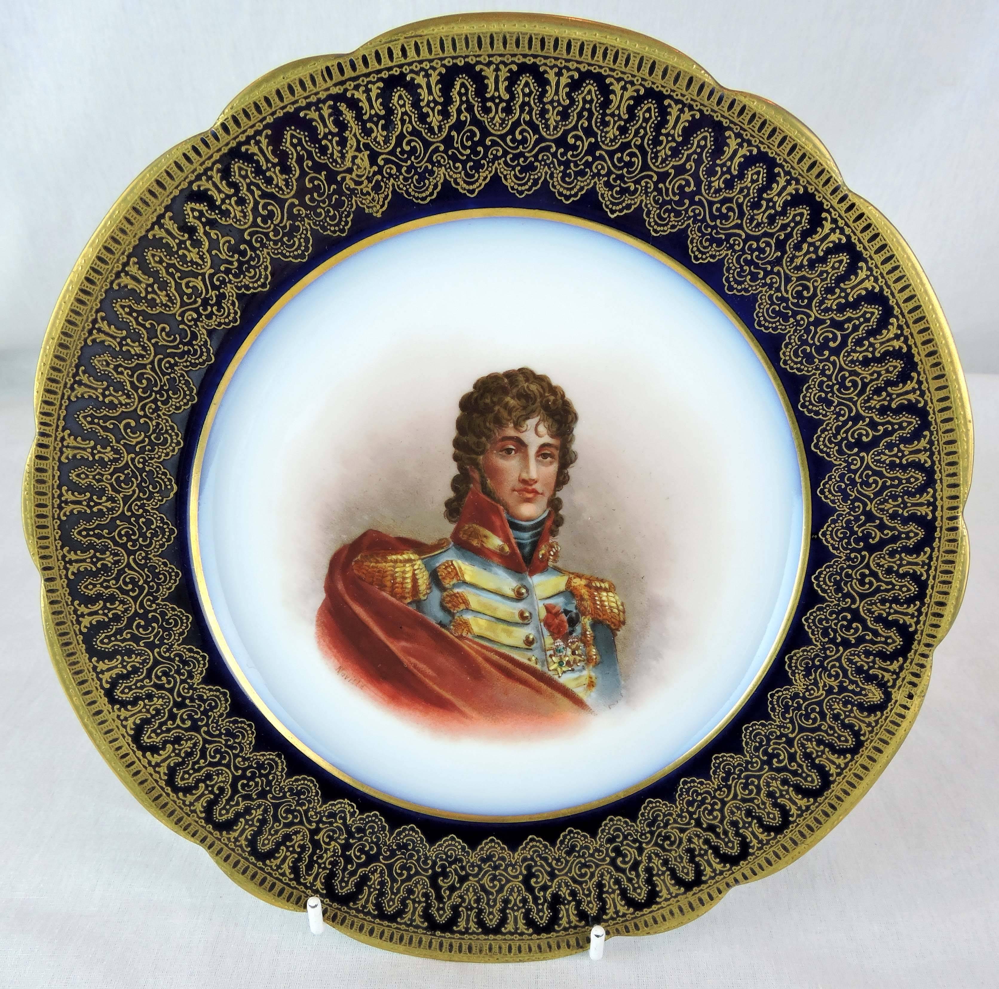 This pair of Sèvres porcelain portrait plates has scalloped, cobalt blue rims, overlaid with raised dentelle gilt and gilt trim along the outer edges.

The centres of the plates feature hand-painted, signed portraits: one of Madame Pompadour, the