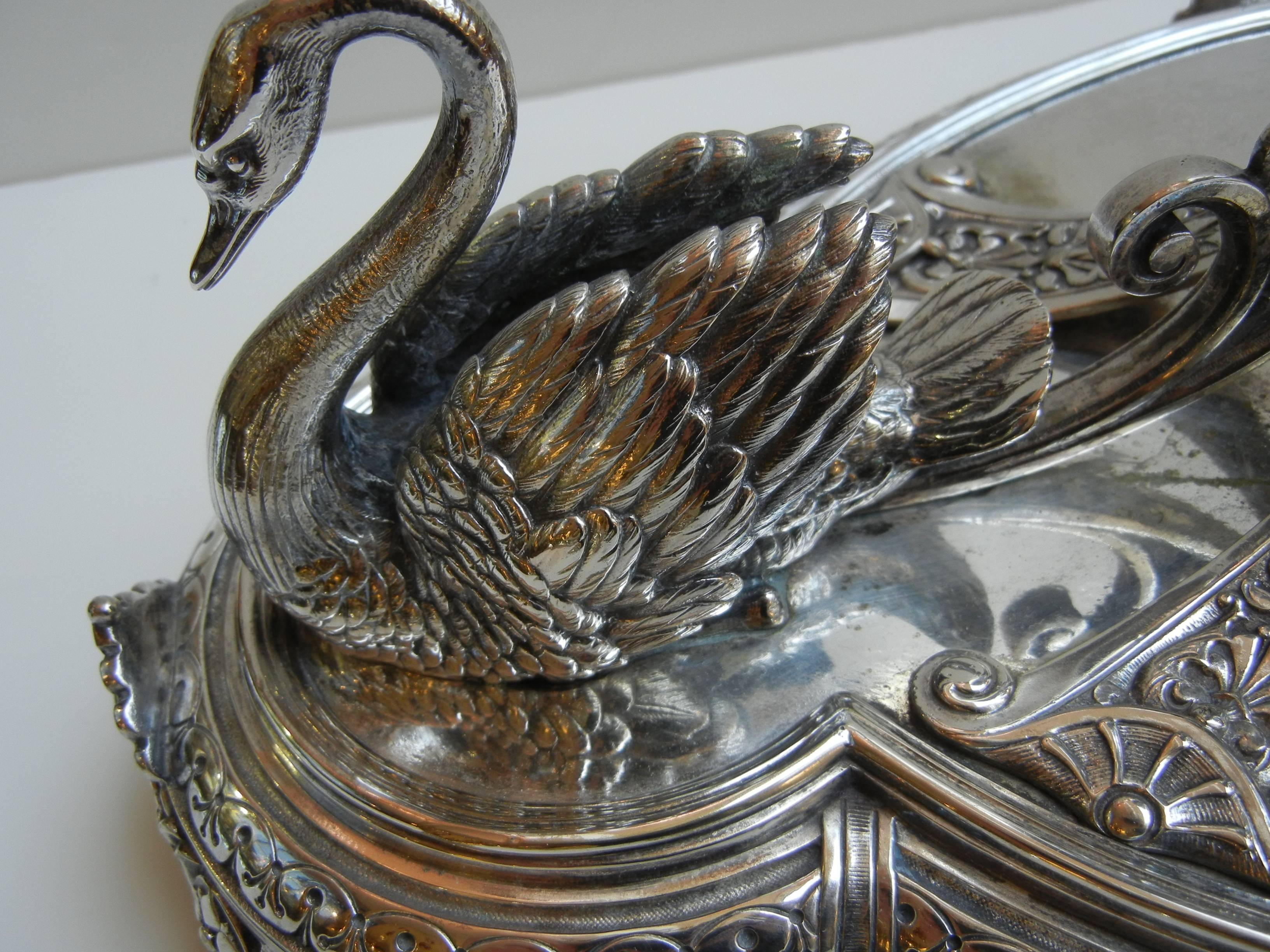 A fabulous large Elington & Co. table centrepiece having swans on two ends raised in the center with a beautiful red cut to clear Bohemian crystal bowl.

Marked Elkington & Co. on bottom.

Measures: 19.5 inches long x 17.5 inches