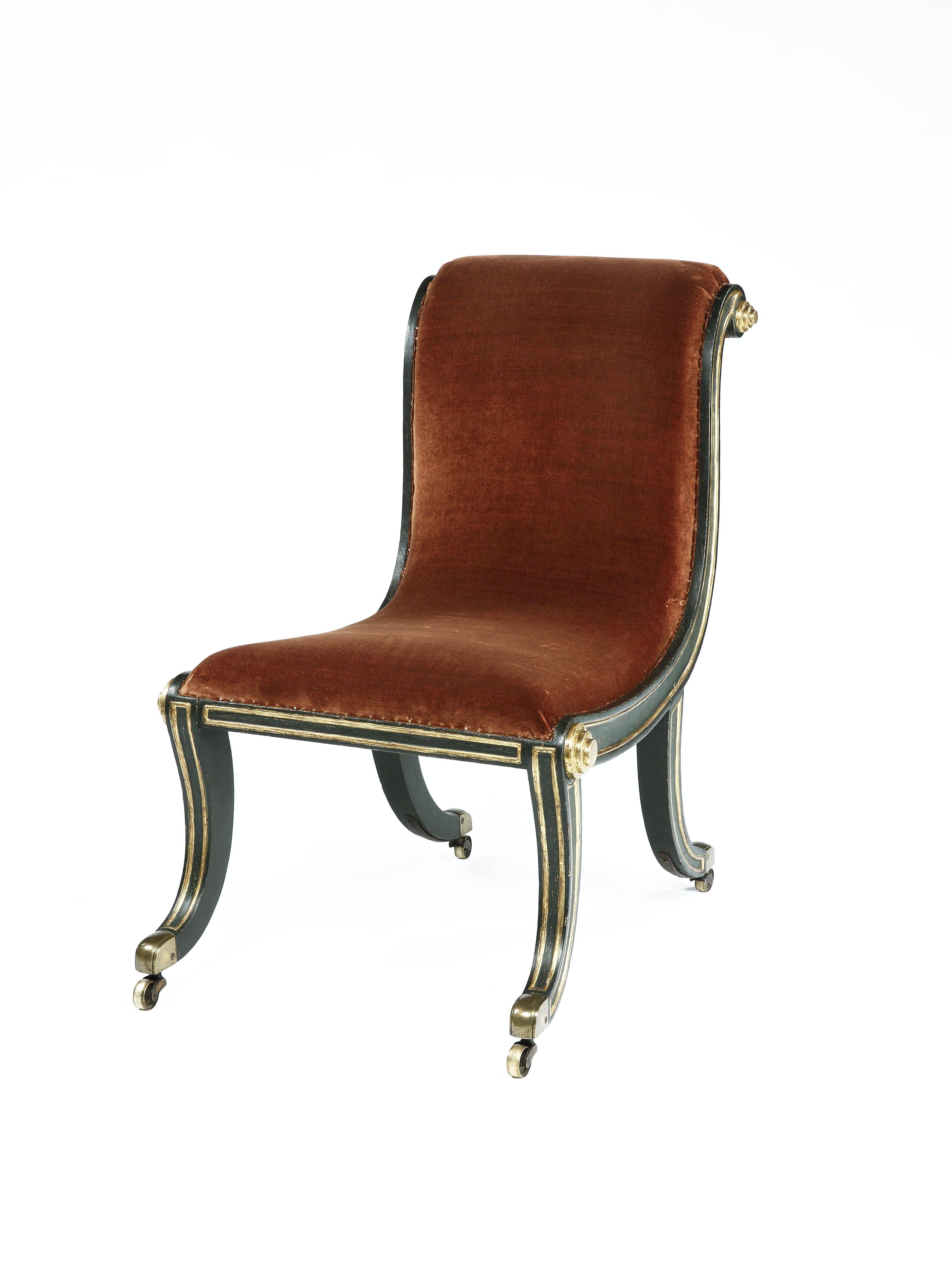 Carved giltwood and faux bronze painted frame of elegant curvaceous and scrolling form, on sabre front legs and exaggerated swept back rear legs with casters, traditionally upholstered with hand-stitched horsehair and covered with