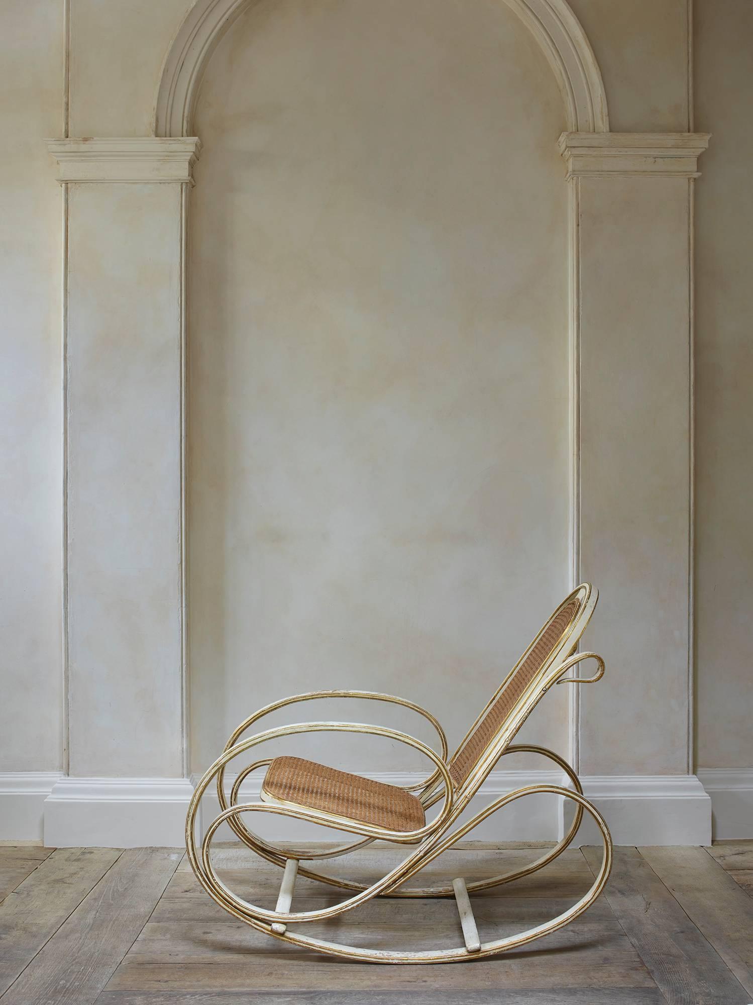 Model no. 269.

Retaining its original lacquered and gilt surface. Steam-bent beech with caned seat and back, each side composed of a single continuous molded member in a series of complex curves.

Manufactured by Societa Anonima Antonio