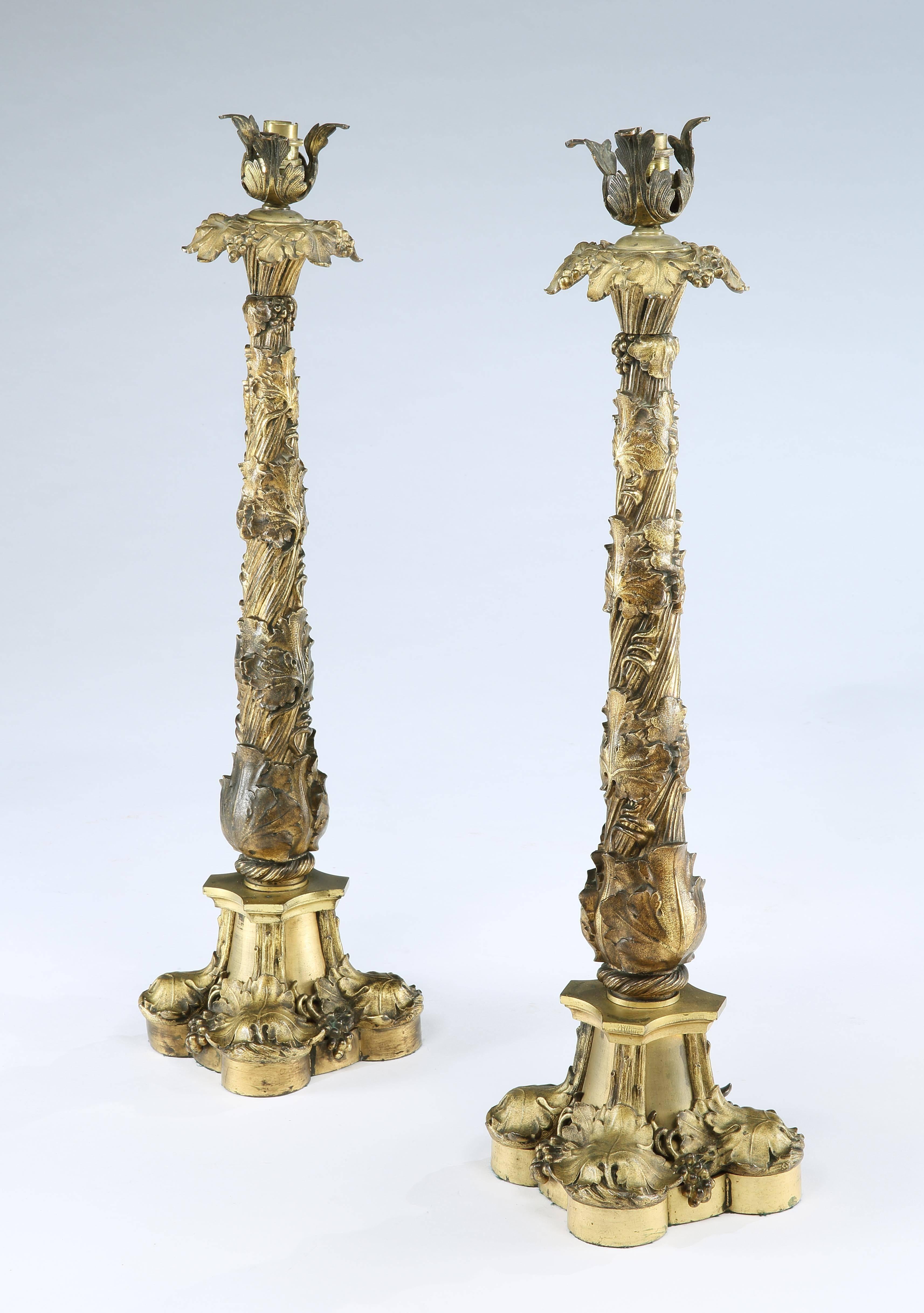 Attributed to Thomas Messenger & Sons

England, circa 1835

Both lamps with a quatrefoil base decorated in finely cast vine leaves and grapes leading to the column in the form of a twisted vine branch intertwined with leaves surmounted by a