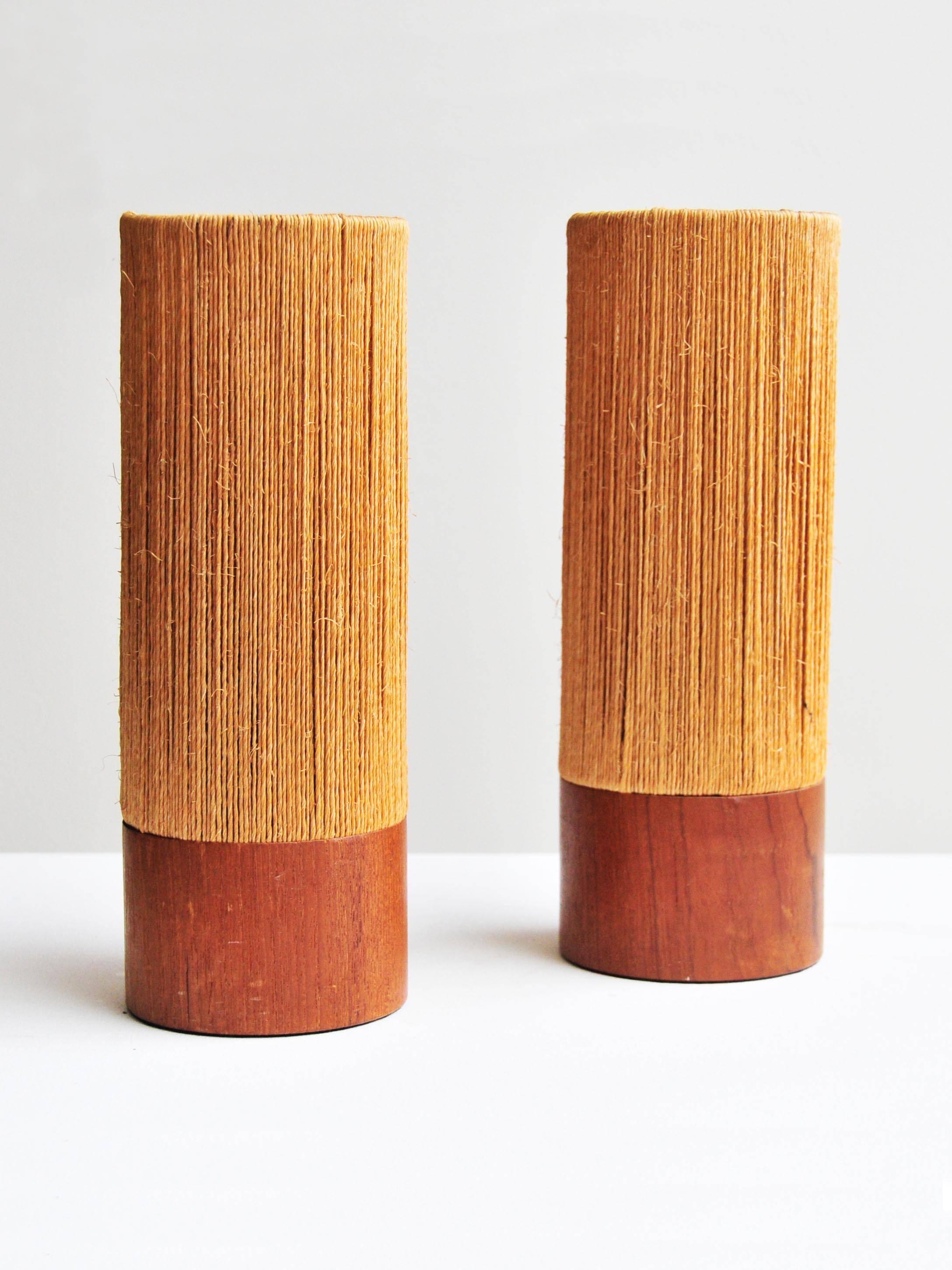 Of simple cylindrical form with teak wooden bases supporting delicate rope shades,

France, mid-20th century.