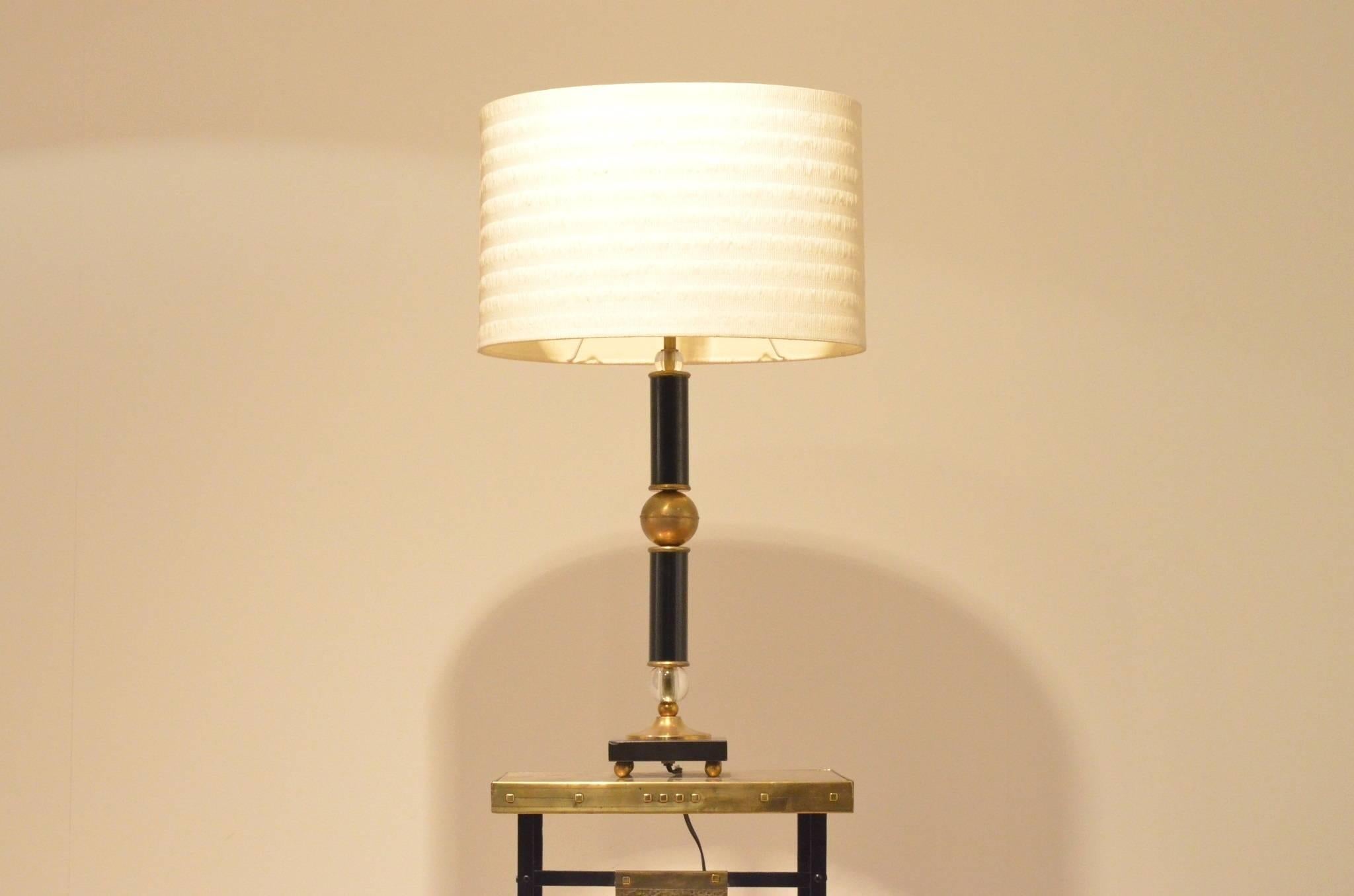 Beautiful Mid-Century table lamp attributed to Jacques Adnet. All materials and stylistical elements used by him are present: Glass and brass balls / black painted lacquered metal cylinders / black marble base.