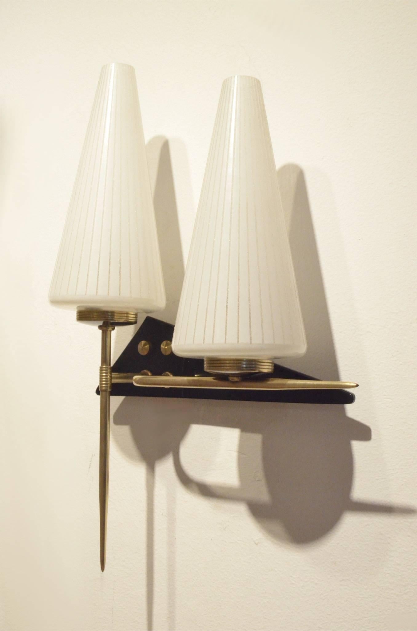 Set of 2x Mid-Century wall sconces from Maison Arlus, triangle shaped black plexiglas bases matching brass elements and cone shaped glass diffusers.