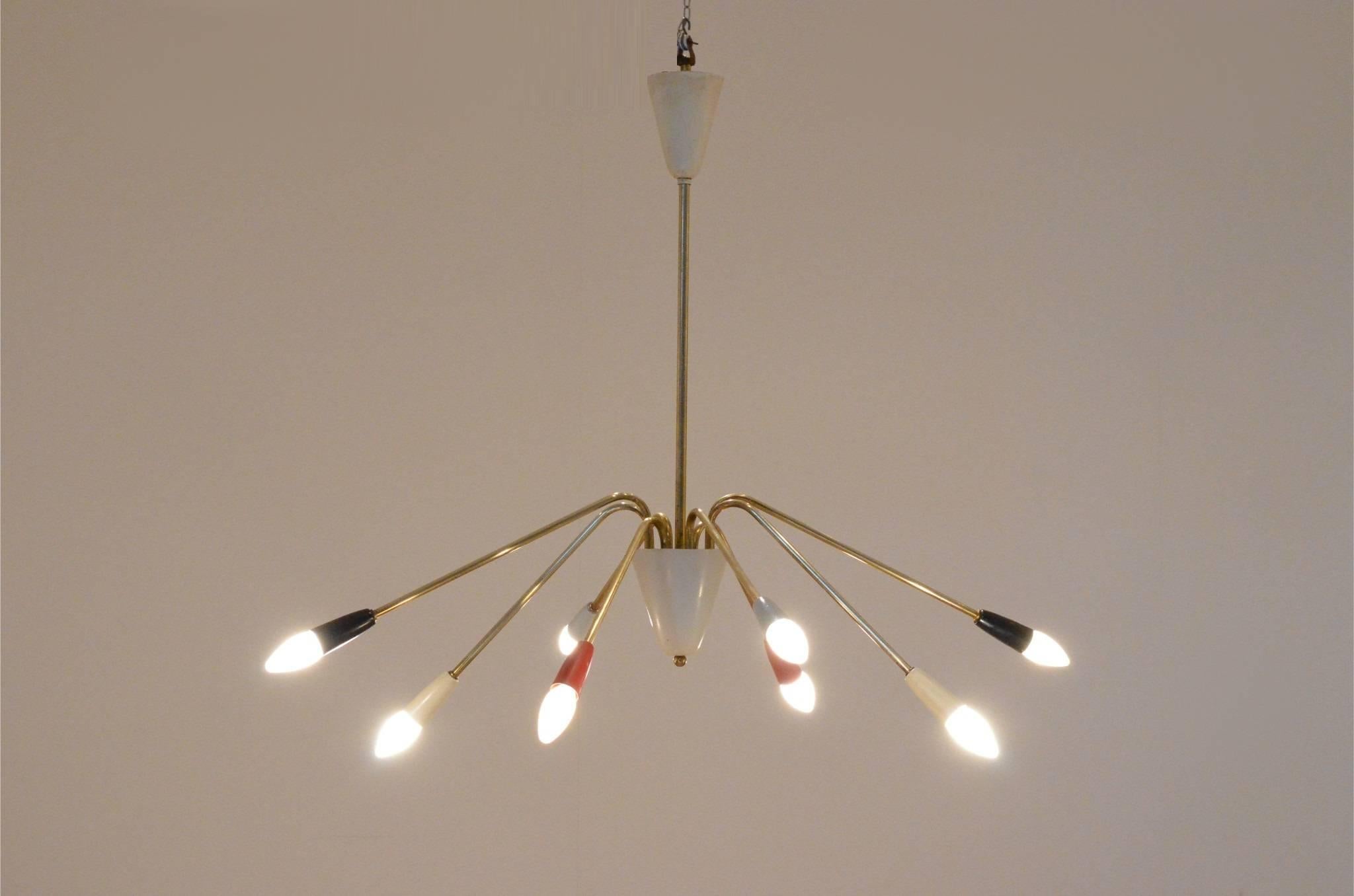 Highly decorative Mid-Century Italian chandelier, most probably manufactured by Arteluce. Quadricolor painted metal endings matching brass arms.