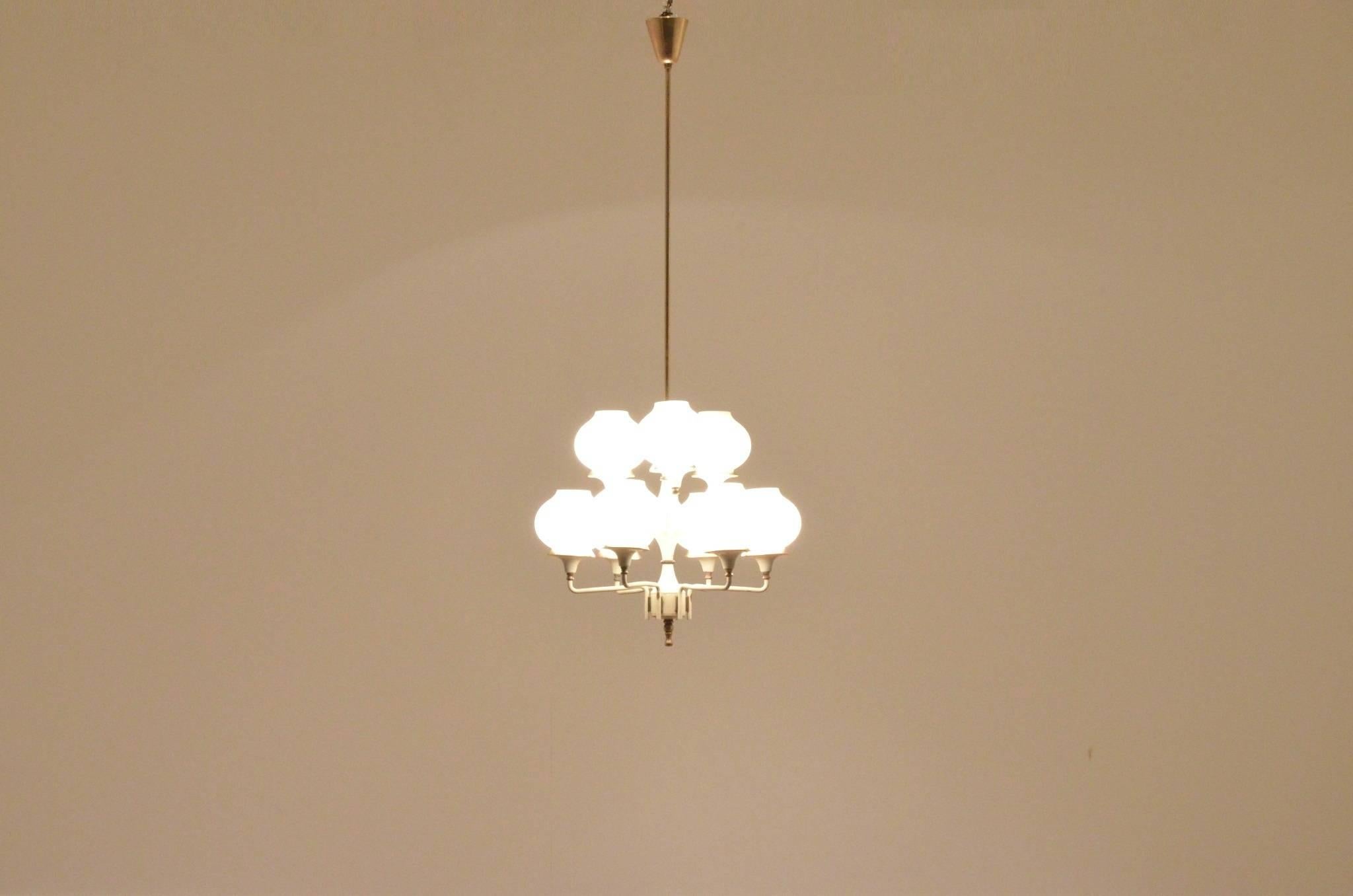 Exquisite midcentury Italian chandelier in the manner of Stilnovo - the structure is composed of two layers of round opalescent glass diffusers matched with brass accents, the main frame is cream / white painted brass.