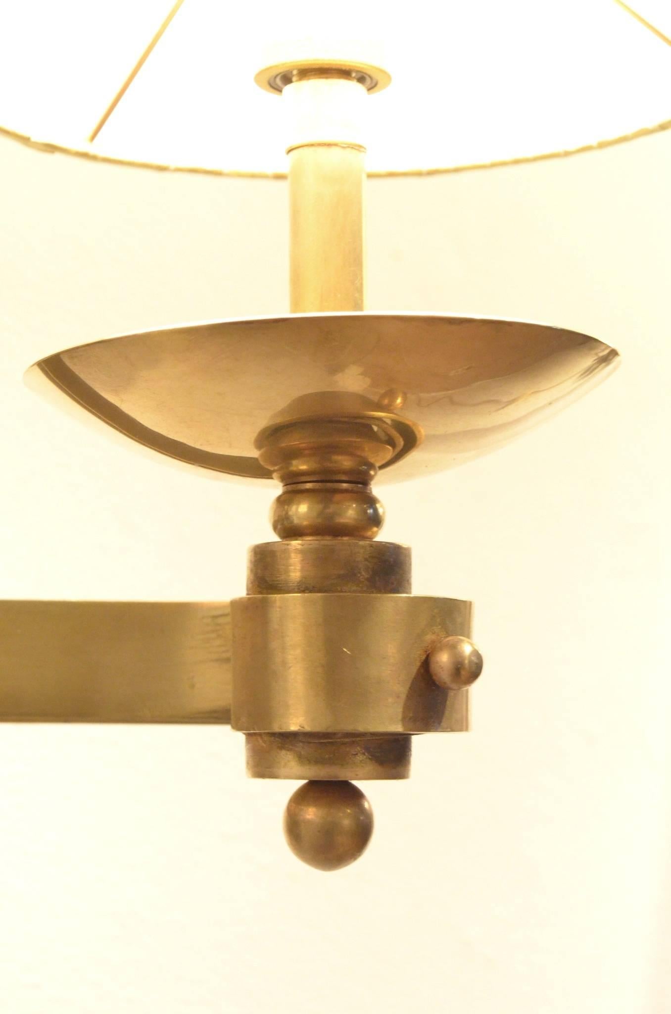 Set of three extra large sized wall sconces from the 1930s in the style of René Drouet and originating from a Hotel near Deauville, outstanding curvy brass structures matched with new textile shades.