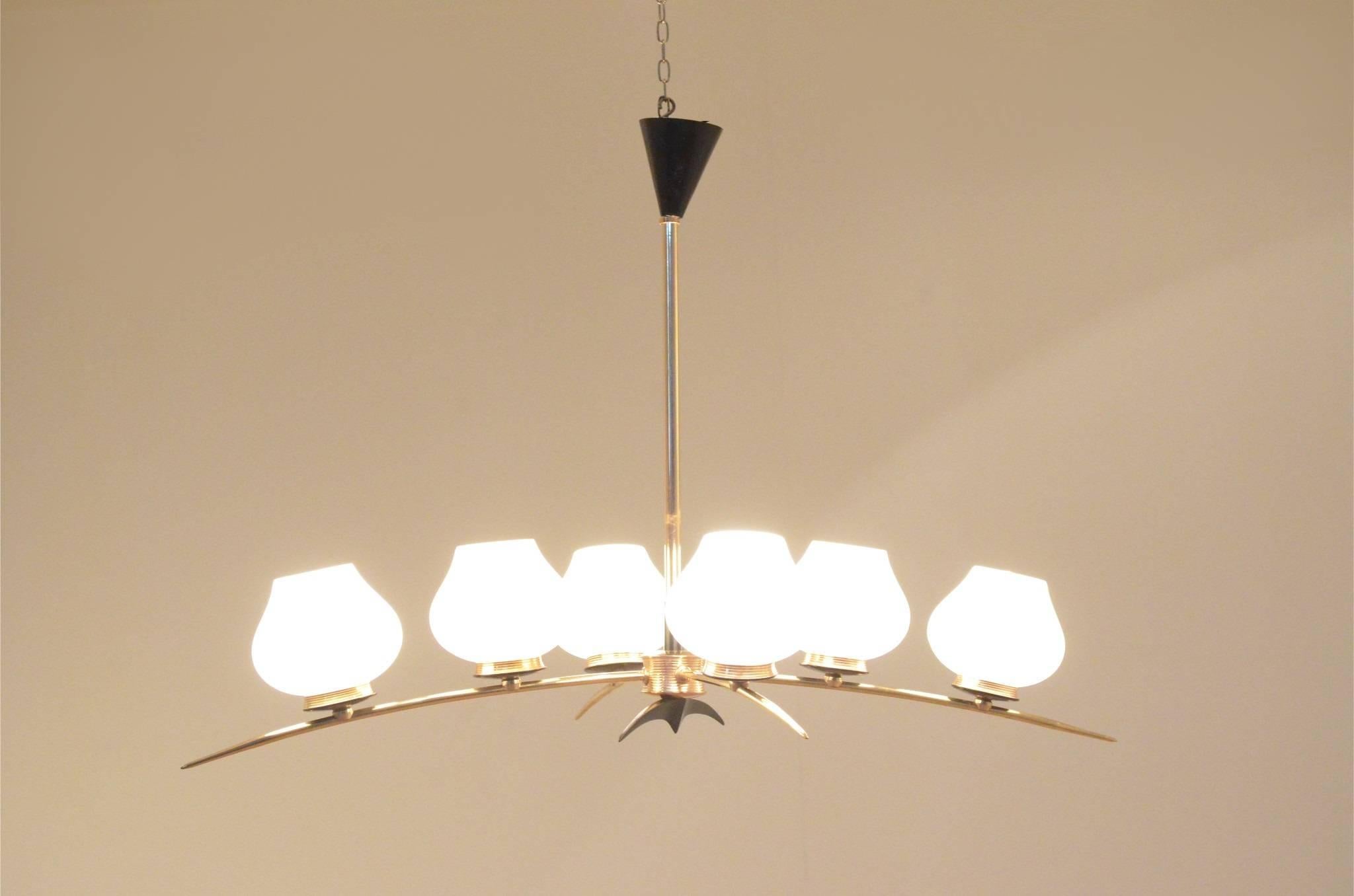 Decorative Mid-Century Maison Arlus French chandelier, arc shaped brass structure with brass and black painted elements. Opalescent glass diffusers in the shape of pears.