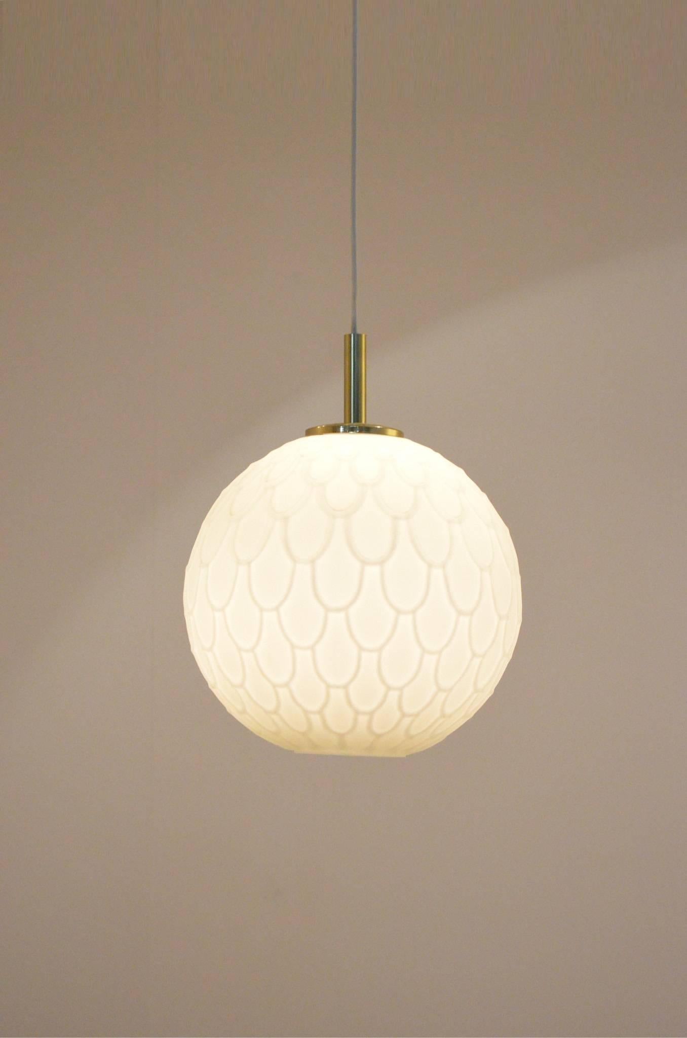 Peil & Putzler Opalescent glass ball shaped pendant lamps with brass endings mat ball version. 
Also for sale on our 1stdibs shop a pair of overglazed ball lamps.


