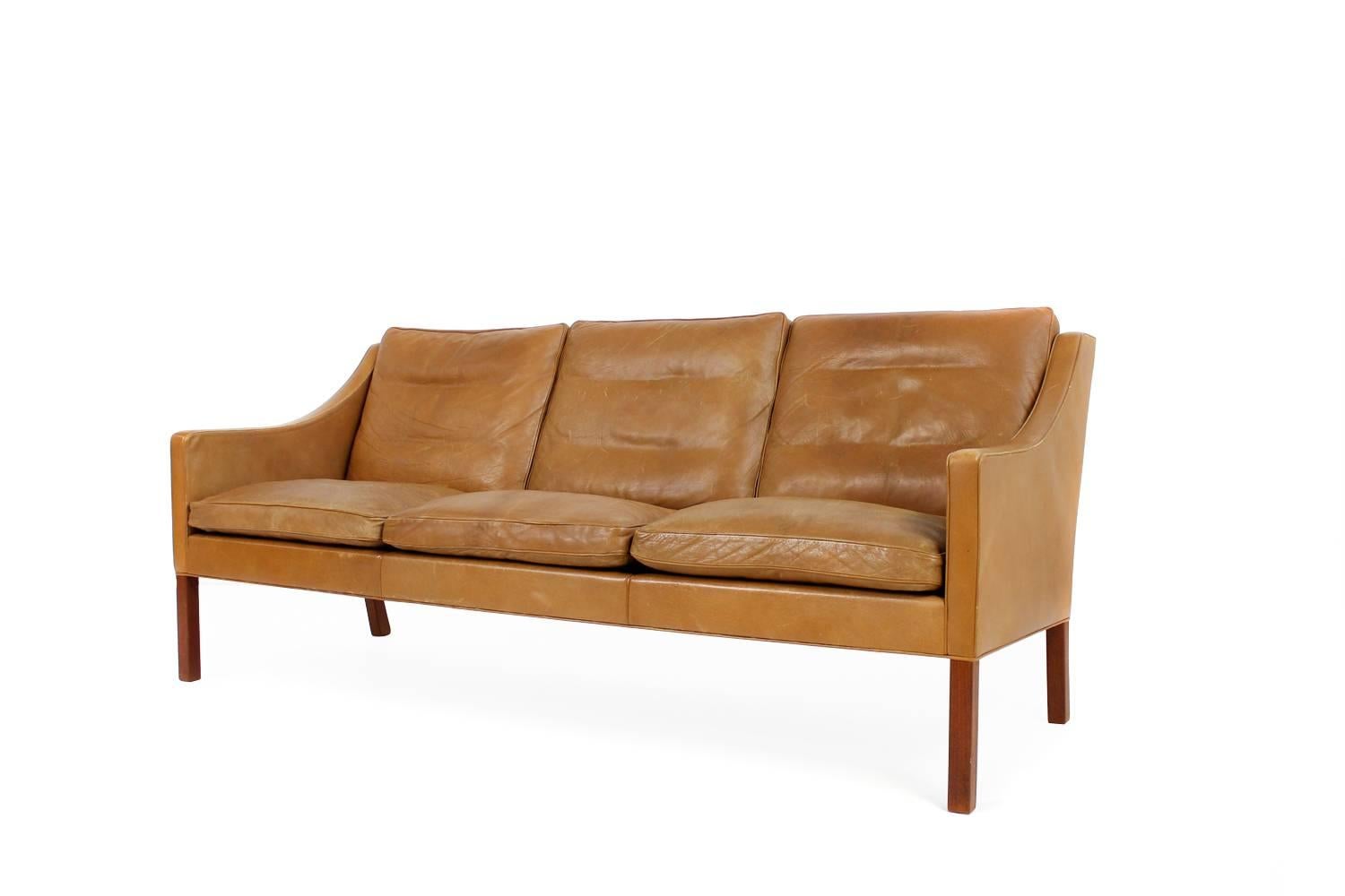 Borge Mogensen Sofa Mod. 2209 made by Fredericia Denmark.
It was bought in 1971 has the original leather with only minor wear consistent with age, down filling. Overall a beautiful vintage condition, Teak base. Danish modern design. Fredericia