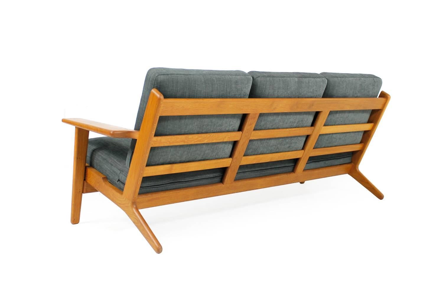 Beautiful Hans Wegner sofa, solid oak, very good condition, newly reupholstered and covered with high quality, soft woven fabric. Innerspring cushions, overall high quality, like all Wegner designed furniture.
Model GE 290 and mady by Getama,