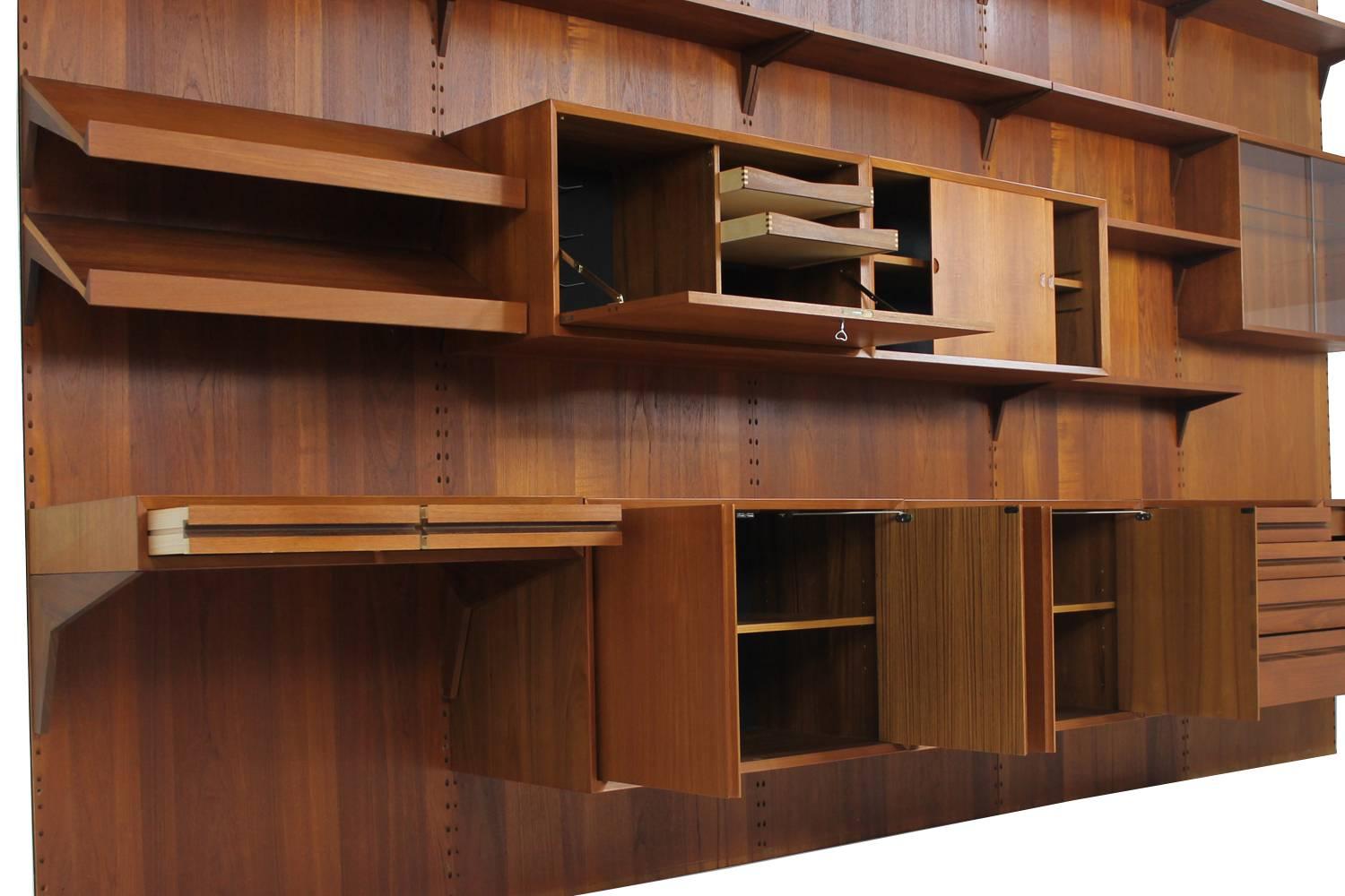 Beautiful and large Royal Teak wall unit designed by Poul Cadovius and manufactured by Cado, circa 1960 in Denmark. This modular system can be assembled as desired and features large cabinets with plenty of storage space. Dimensions of the