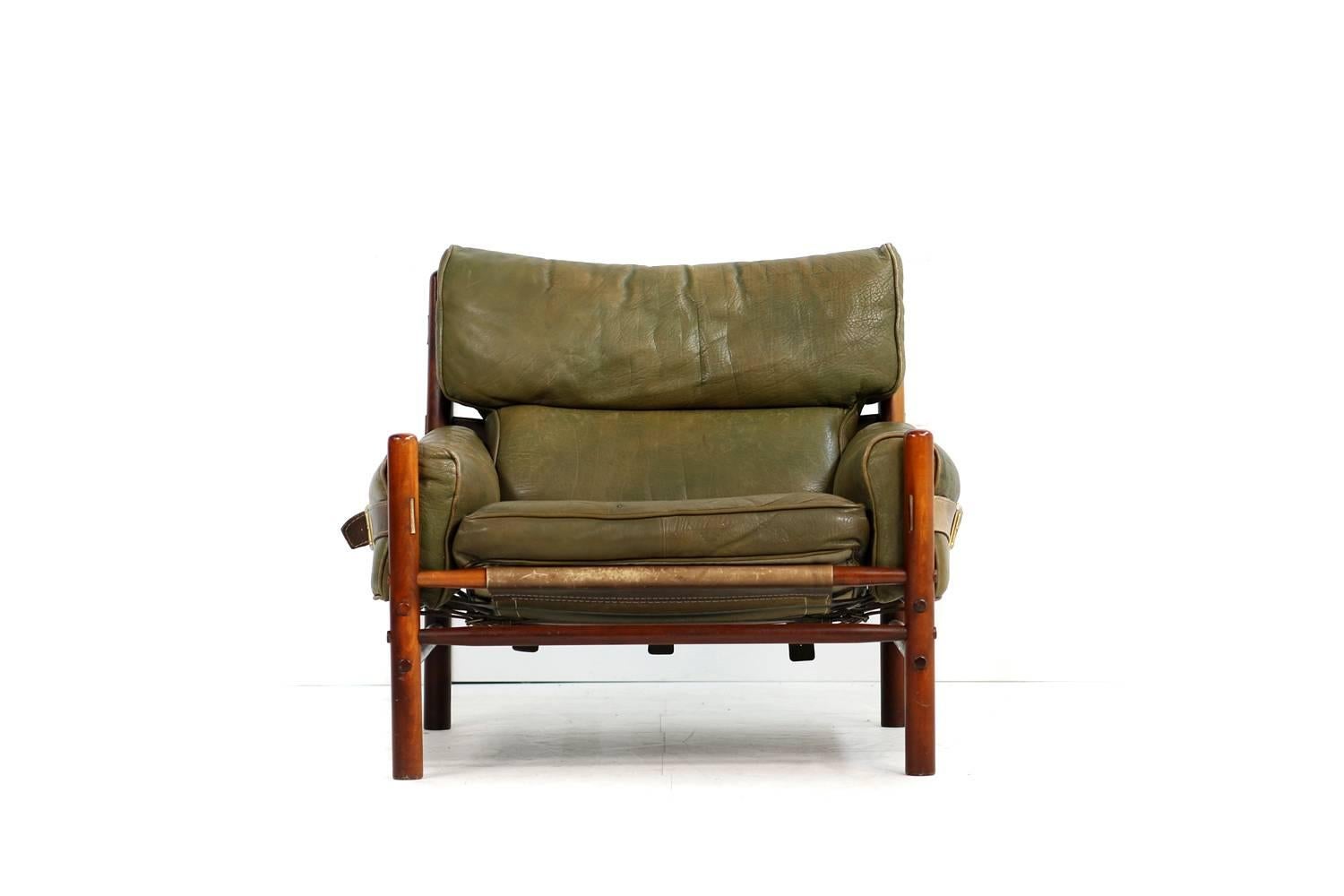 Beautiful vintage and authentic Arne Norell leather lounge chair, made by Aneby Mobler in Sweden. Mod. Kontiki, in an amazing condition, leather belts and brass parts, stained beechwood, also the base in a very good condition.