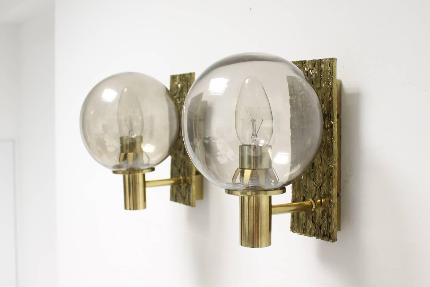 Fantastic pair of 1960s sconces, brass and glass, gold-plated. Beautiful Brutalist base, smoked glass, each wall lamp for one E14 bulb. Electronics was checked, sconces work in Europe and also in the US or Asia. Great sconces in the style of