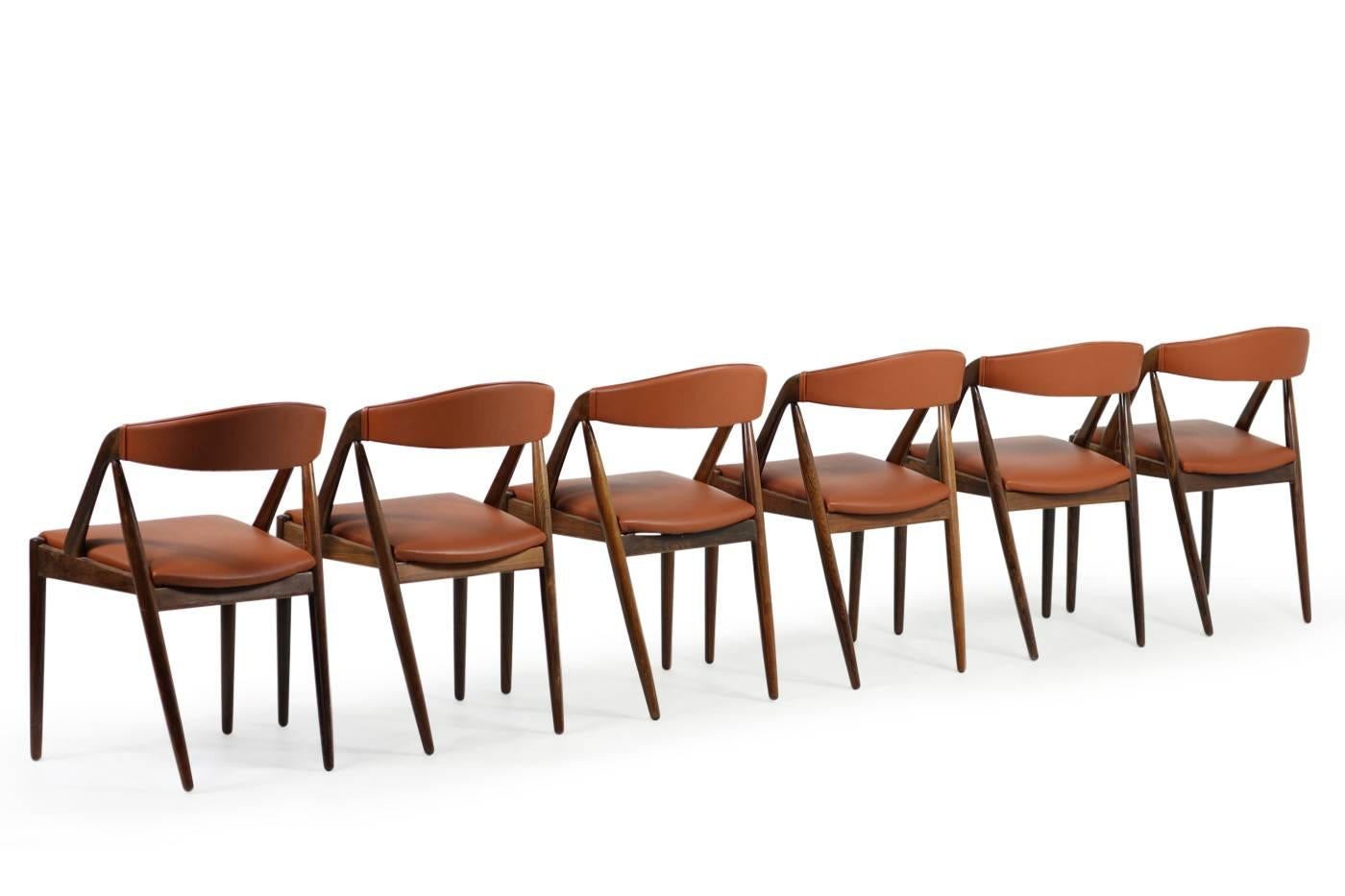 Beautiful set of six Kai Kristiansen rosewood dining chairs, Model 31 in beautiful condition. New upholstery and high quality cognac leather, Danish modern design.

  