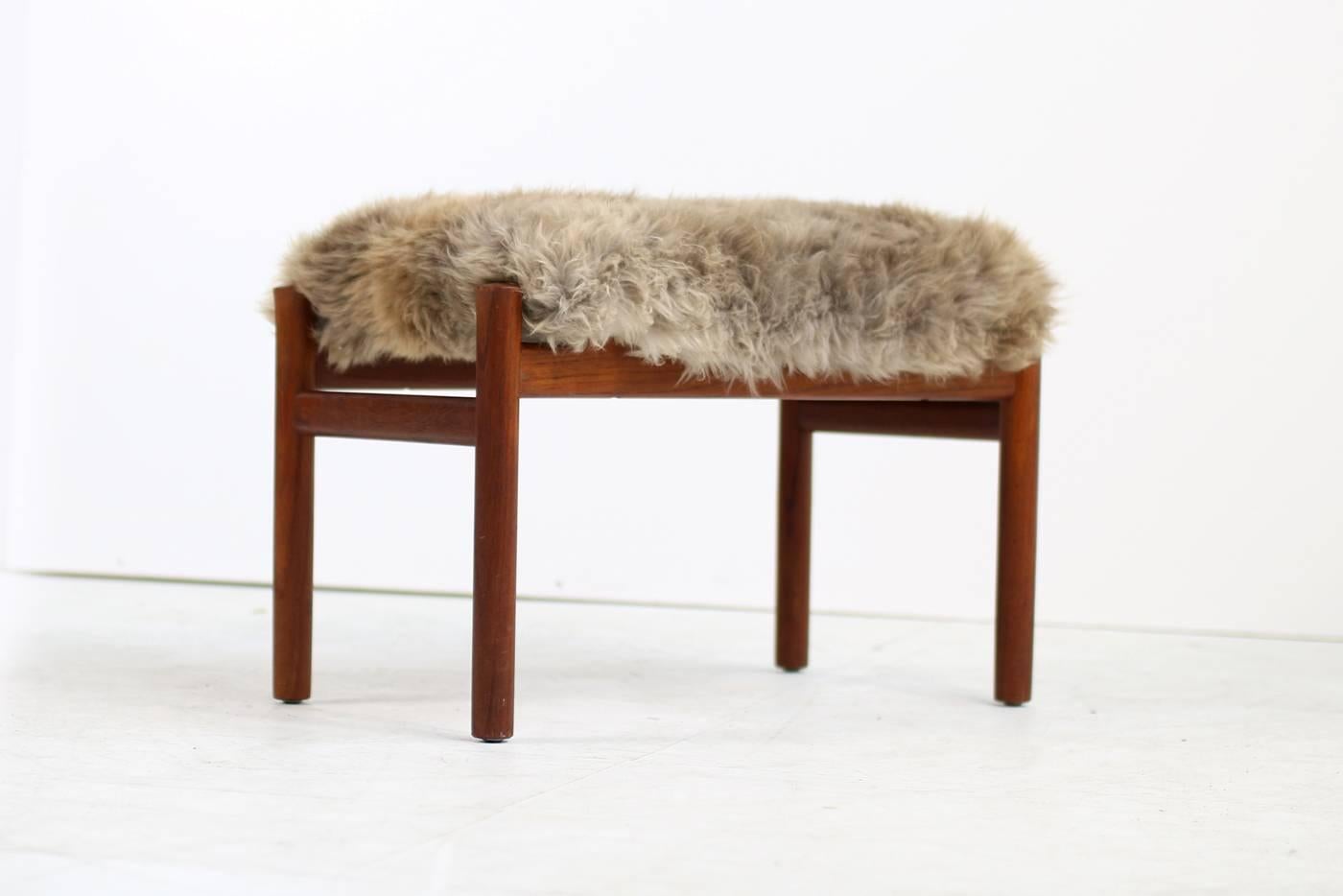 Fantastic 1960s danish modern teak stool with real sheepskin upholstery in a beautiful natural tone. The teak base is made of solid teak wood, great condition. In the style of Philip Arctander and Mogens Lassen or Flemming Lassen, exact designer