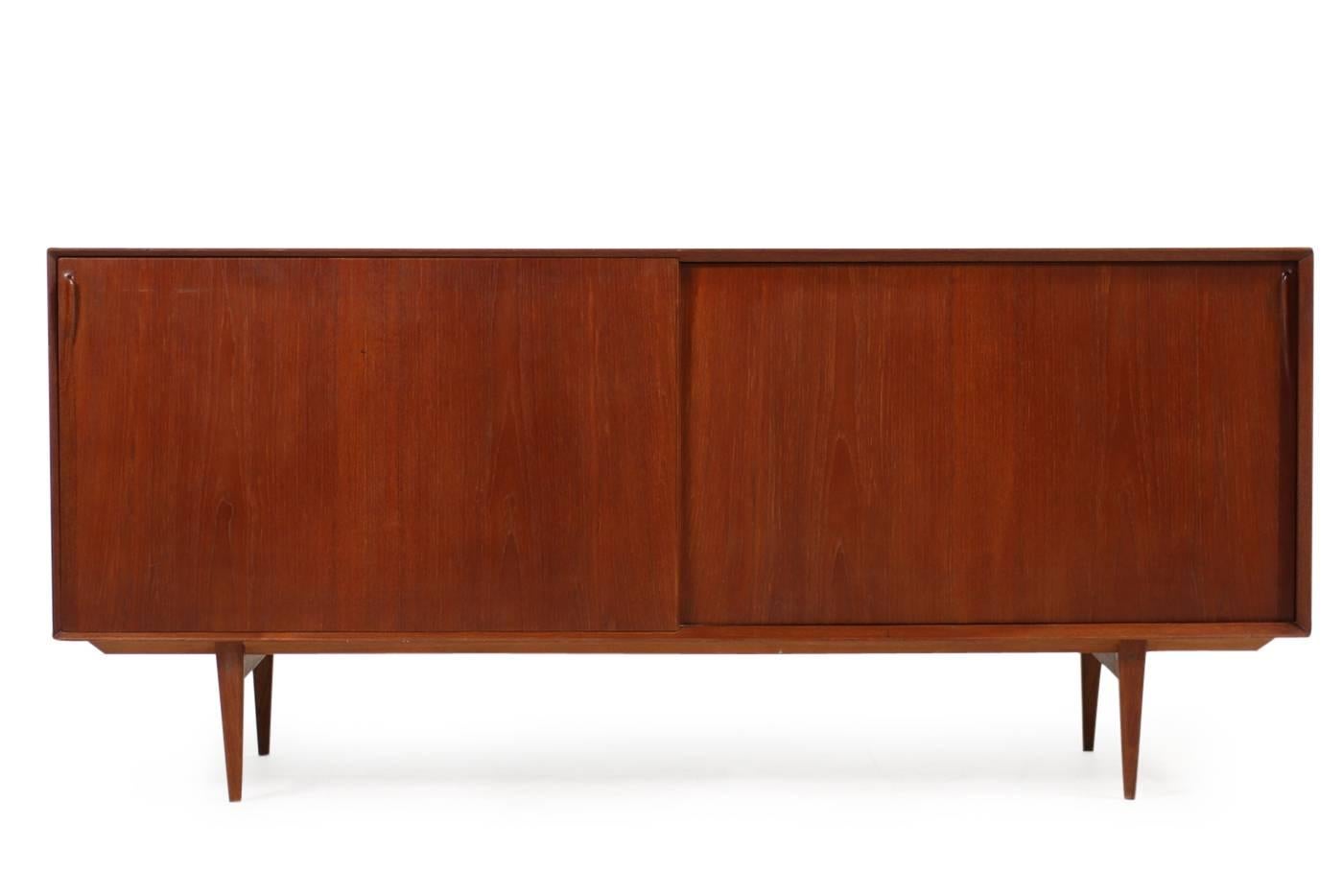 Rare 1960s, Vintage Teak Rosengren Hansen Sideboard by Brande Mobelfabrik, marked. Early 1960s edition, two sliding doors and drawers inside, also adjustable shelves.