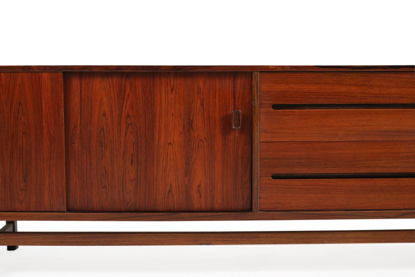 Beautiful 1960s sideboard by Nils Jonsson, very rare rosewood sideboard, Troeds, Sweden, maple wood inside, four drawers, two sliding doors and a bar, adjustable shelves inside, fantastic condition. Beautiful and rare Scandinavian Modern sideboard,