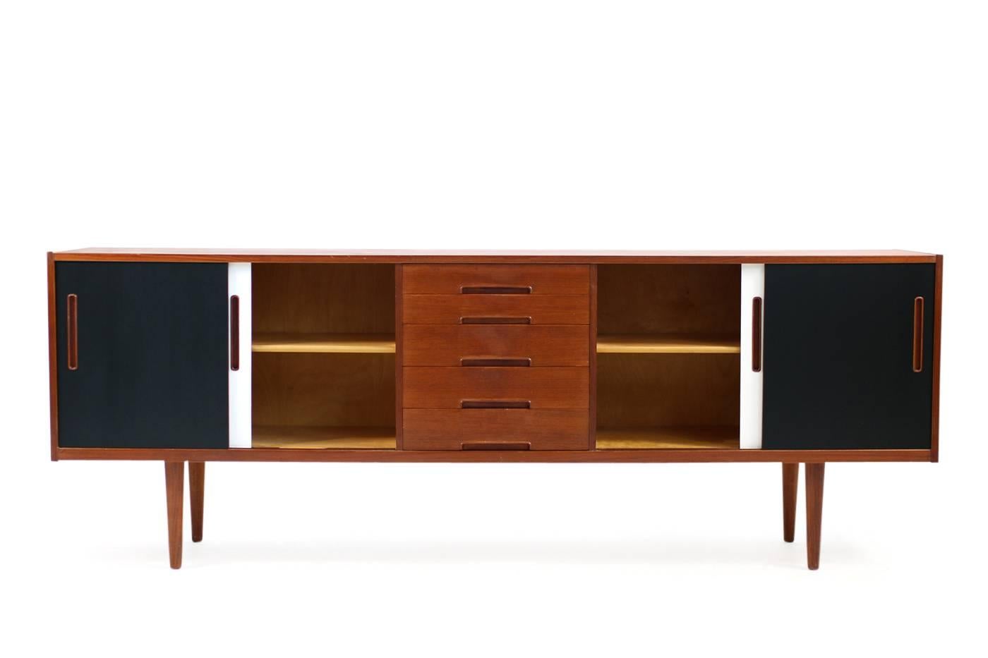 Beautiful 1960s sideboard by Nils Jonsson, made in Sweden by Troeds. Teak sideboard in very good condition, the top is excellent and the painted sliding doors in black & white look amazing. Maple wood inside, five drawers. Rare piece in a