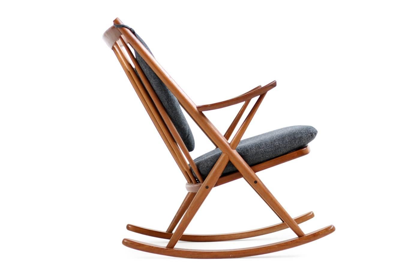 Beautiful 1960s Danish modern rocking chair, solid teak and renewed upholstery in grey wool. Very good condition. Made in Denmark by Bramin, designed by Frank Reenskaug, model 182.