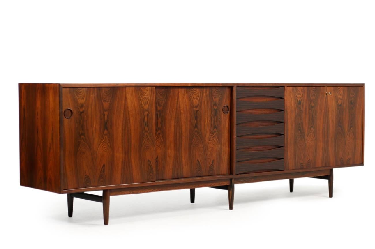 A beauty in very good condition. The rare sideboard was designed by Arne Vodder, produced by Sibast Furniture, Denmark in the 1960s. Model 29A with two sliding doors, seven drawers and a bar door, very clean inside, good vintage condition, minor