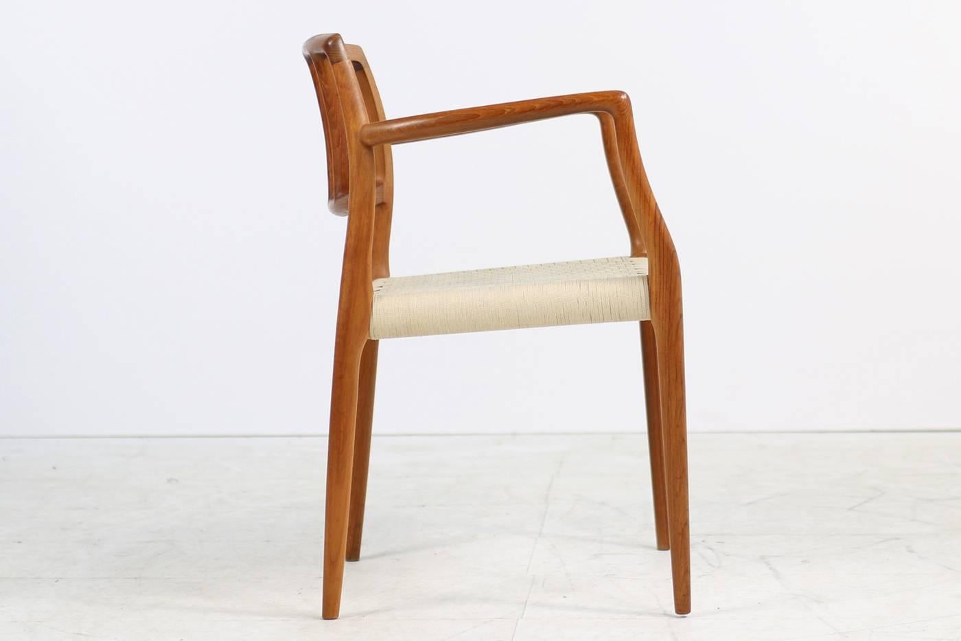 Beautiful and rare Niels O. Moller teak armchair, model 66 for J.L. Moller, Denmark. Fantatic Danish modern design, great condition. The seat is made of flat woven cord of wool string. (The matching stool is also available, please visit our 1stdibs