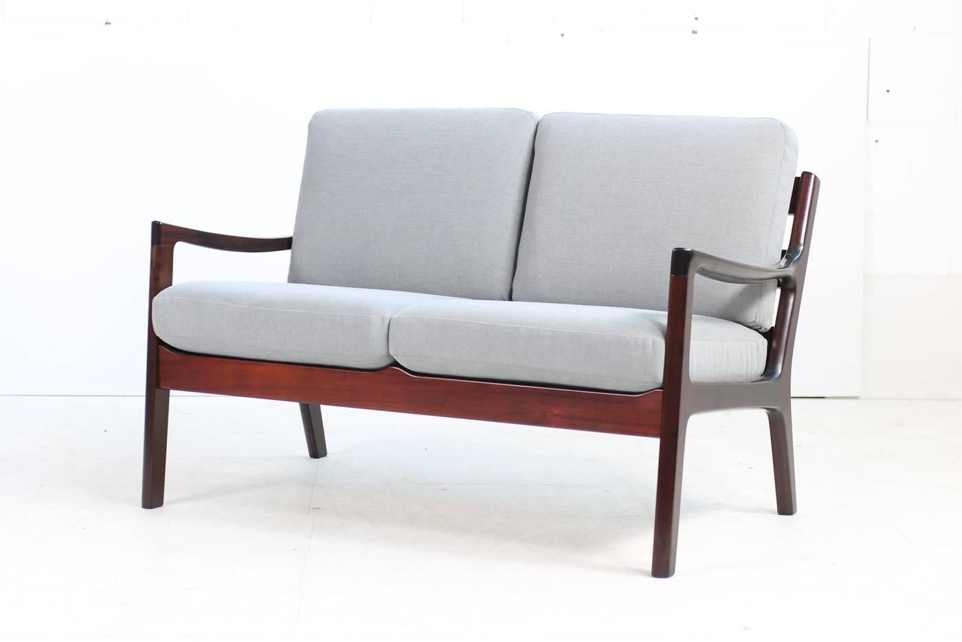 Beautiful 1960s, Ole Wanscher sofa, P.J. Denmark made of mahogany, new upholstery and covered with new high quality cotton fabric in light grey, matching easy chair and three-seat sofa available, please visit our 1stdibs storefront. Some sun fading
