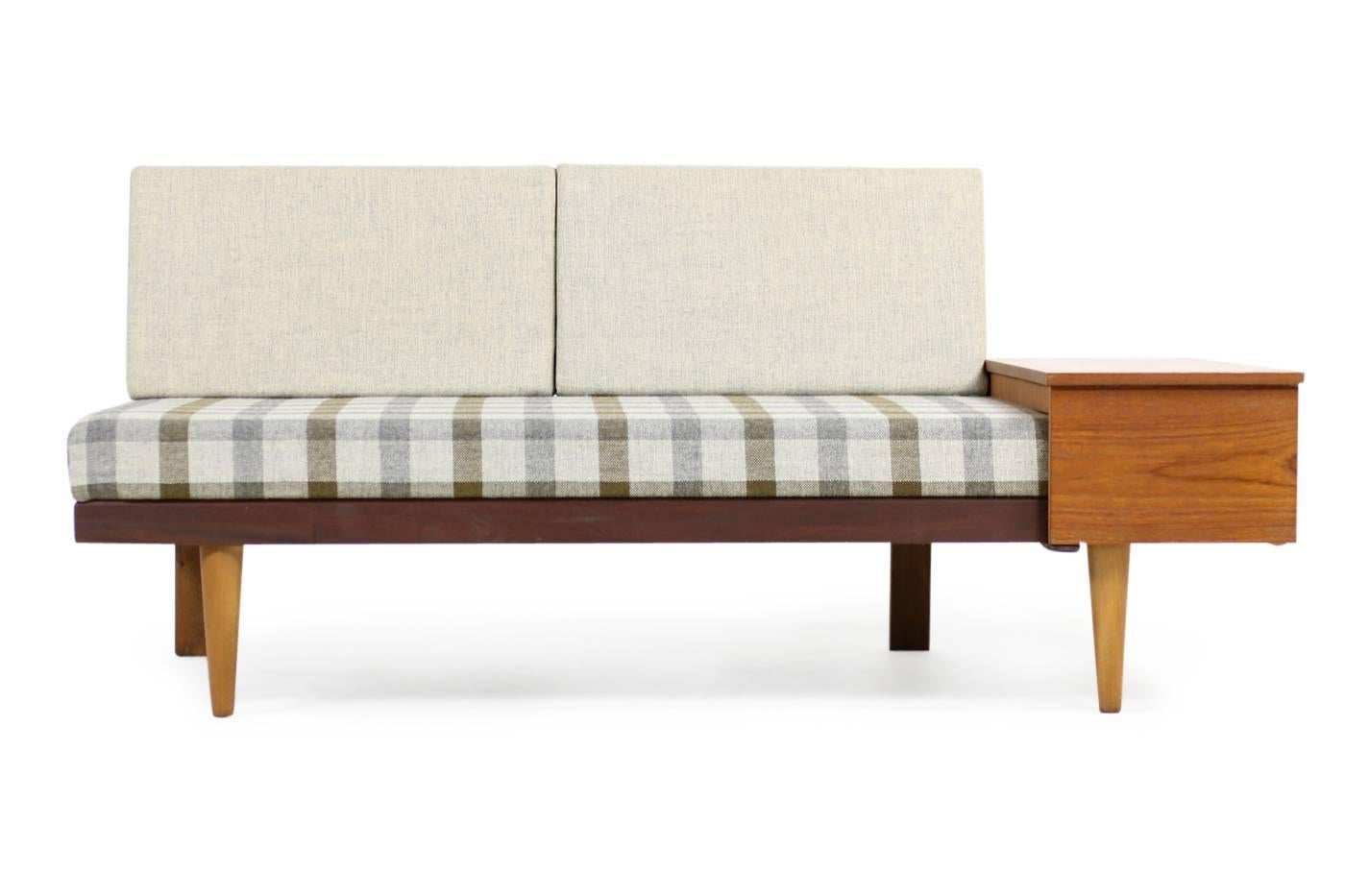 Beautiful Norwegian mid-century modern daybed from the 1950s in fantastic authentic condition. Teak and beech base in great condition, also possible using it as a daybed, the side table can be extended.

Sofa dimensions: W x D x H 161