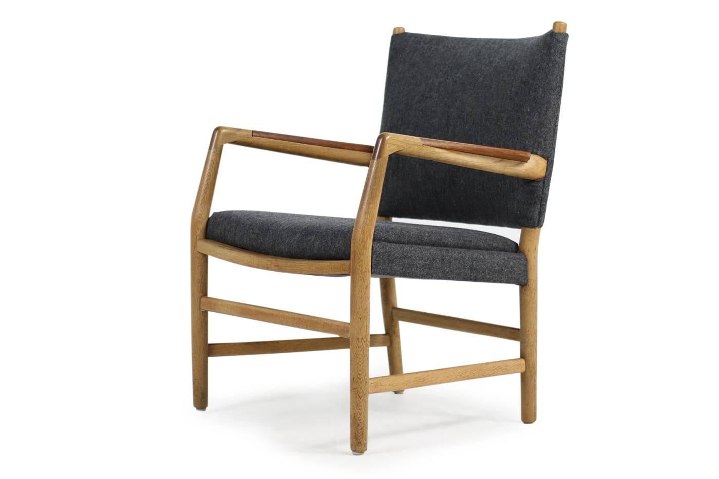 Rare Hans J. Wegner oak and teak armchair, 'town hall chair' with new upholstery and covered with high quality dark grey wool fabric, solid wood, oak base, teak wood armrests. Designed by Hans J. Wegner 1937-1942 for the Danish town hall in Aarhus,