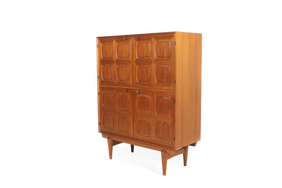 Beautiful and very rare graphic Teak Highboard, with 4 massive doors, overall it's in a mint condition, behind the 4 beautiful graphic doors a plenty of storage space.
Design by Rastad & Relling for Gustav Bauhus Norway.
All keys are present, a