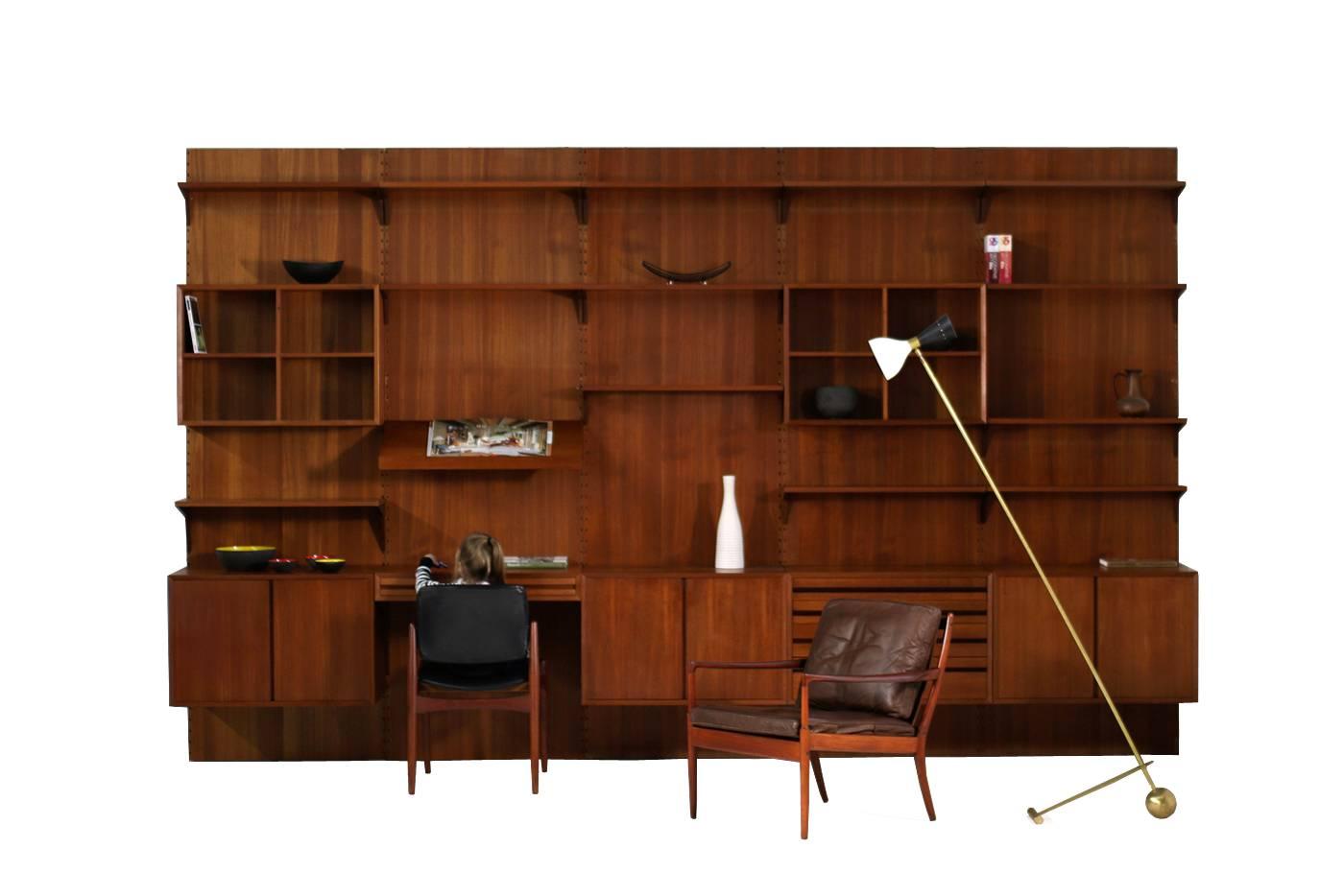 Fantastic and large 1960s teak wall unit designed by Poul Cadovius made by Cado, Denmark. The Vintage Royal Shelving System is in a good vintage condition, some sun fading on the back panels, great patina on all parts, several teak color tones
