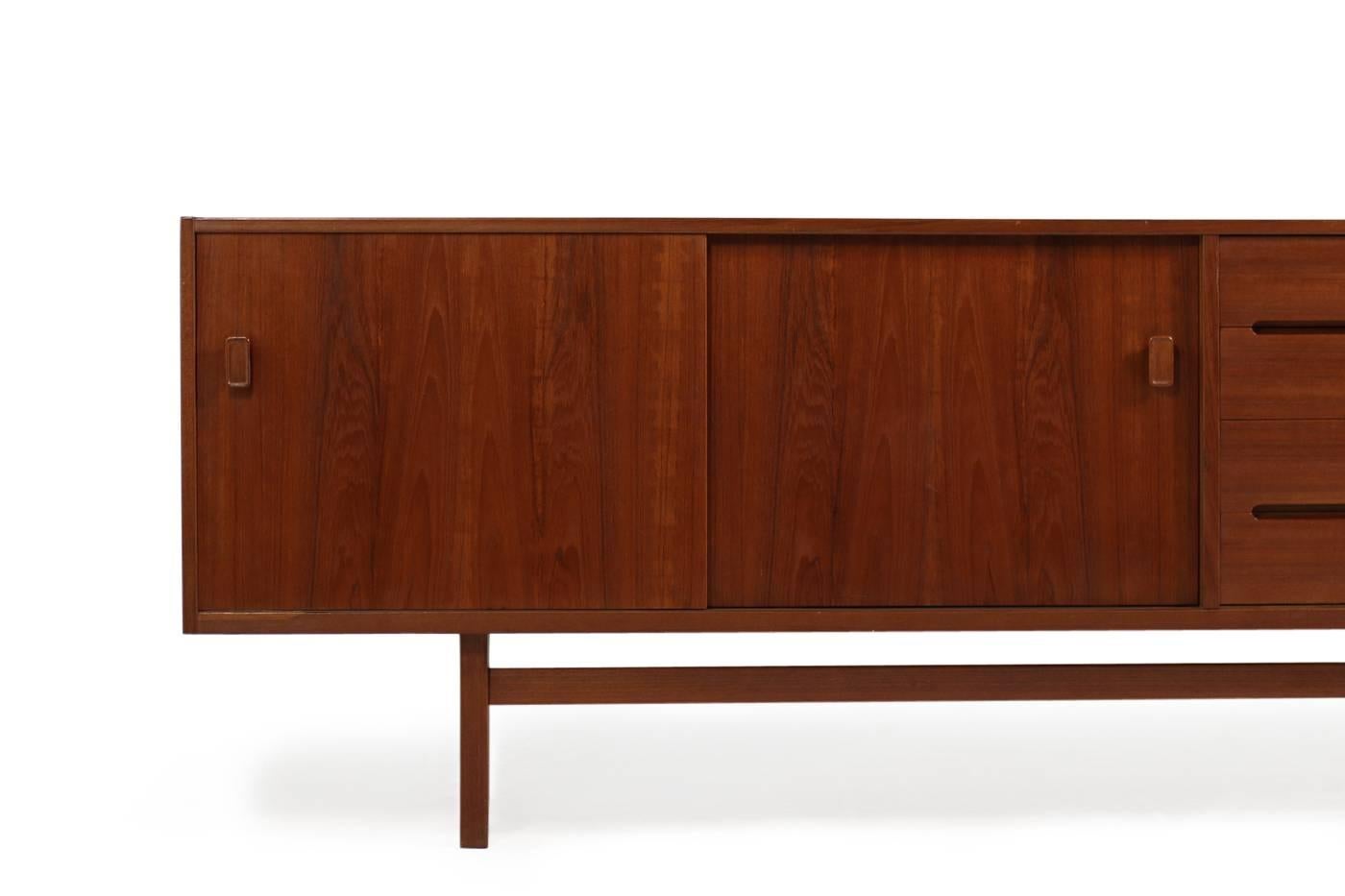 Beautiful 1960s sideboard by Nils Jonsson, very rare teak sideboard, Troeds, Made in Sweden, maple wood inside, four drawers, two sliding doors and a bar with white formica inside, height adjustable shelves inside, fantastic condition. Beautiful and