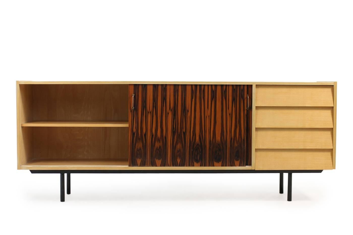 Beautiful and super rare Mid-Century Modern sideboard, 1950s Minimalist design, metal legs, kind of makassar sliding doors with brass handles, drawers, fantastic condition. Most likely a custom work or made to order object, never saw it before. It