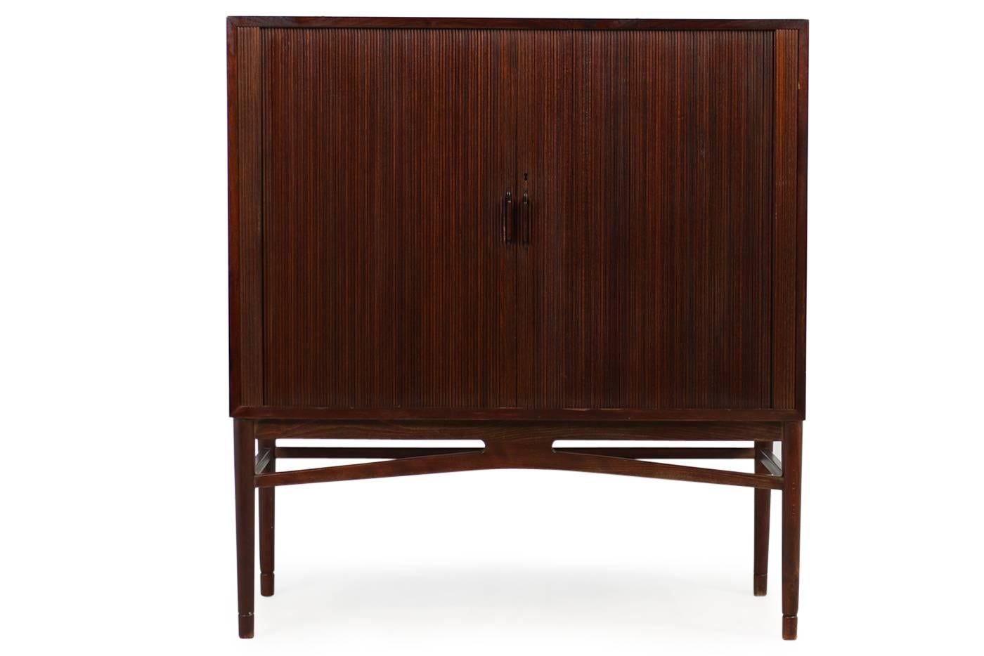 Beautiful, 1960s highboard, Scandinavian Modern, purchased and produced in Denmark, in the, early 1960s
Fantastic condition, tambour doors, maple wood inside, one height adjustable shelf inside. Very rare object in the style of Kurt Ostervig, Arne