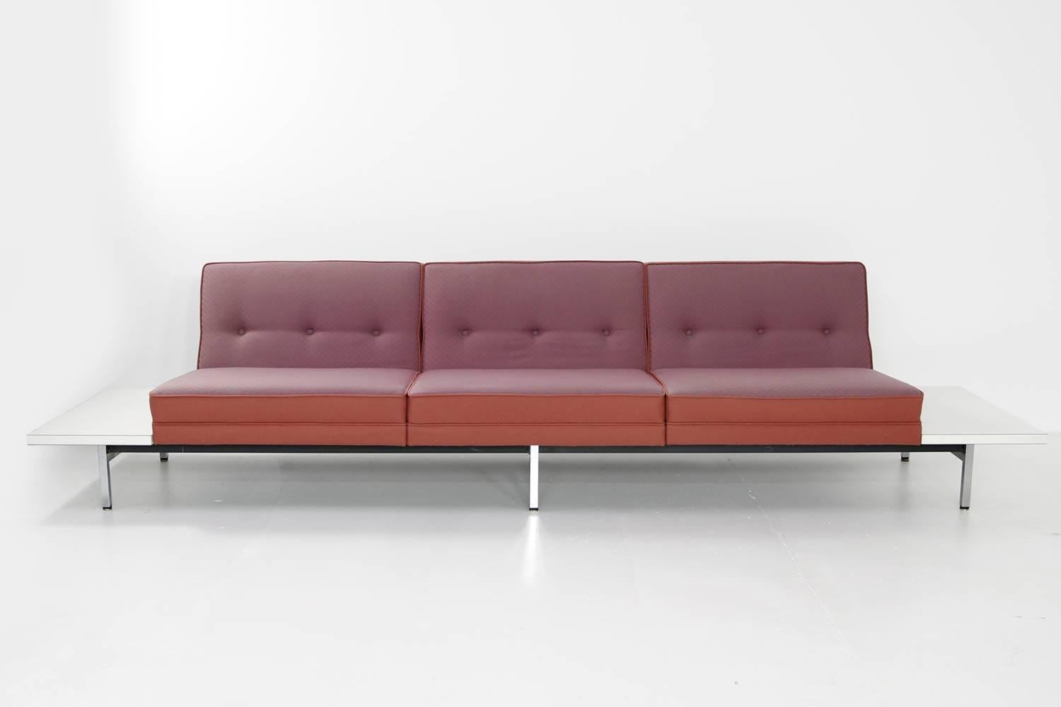 Rare and large modular sofa by George Nelson for Herman Miller. Seats and tables can be arranged as desired, heavy weight iron base with chrome legs.

Two-seat with tables ca. 305 x 76 x 70cm SH 40cm
Three-seat with tables ca. 350 x 76 x 70cm SH