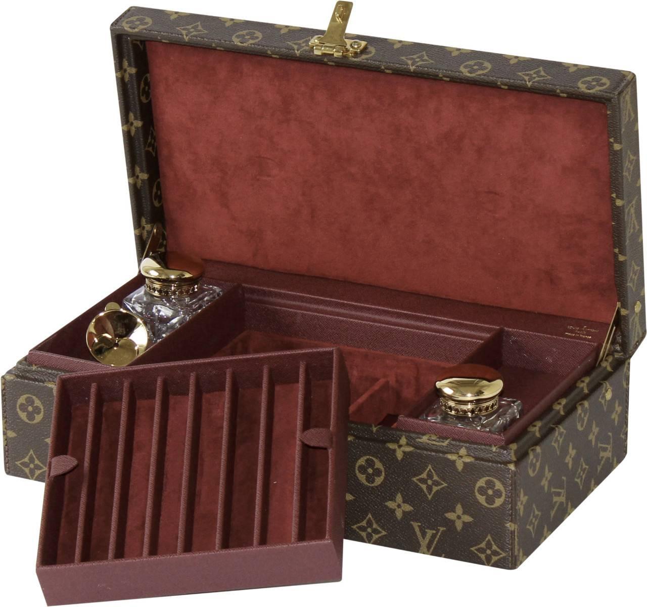 A custom-made piece from Paris, this incredible writing set is complete with two crystal ink wells from the famed St Louis crystal designer. 

Finished in LV monogram exterior with a stunning maroon interior and adorned with brass hardware.