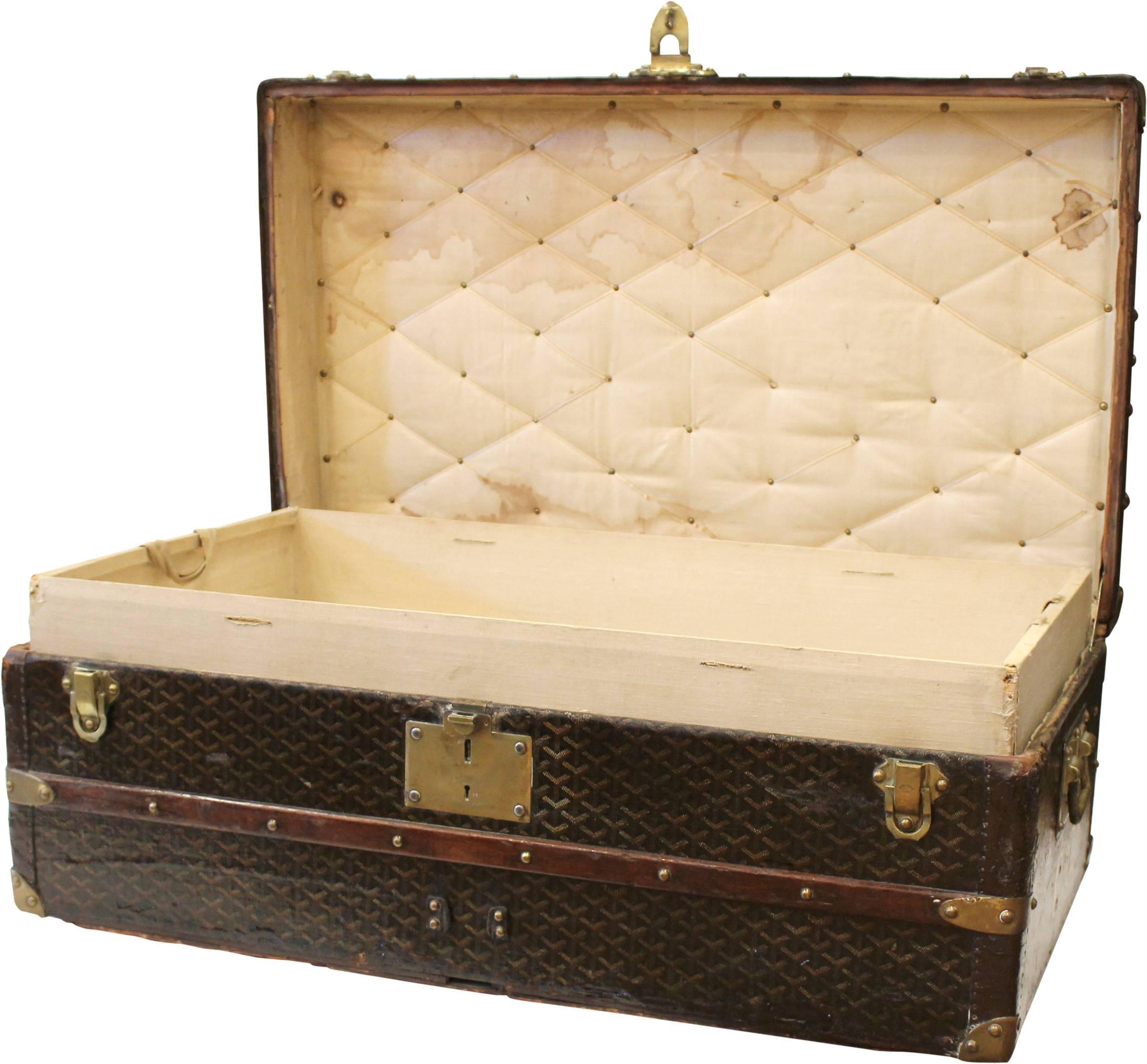 An unusual Goyard cabin trunk in so much as its size and proportions are much smaller than usual. Circa the early 1900s and in the distinctive Goyard St Honore chevron design, the trunk also features rich leather trim and polished brass clasps,