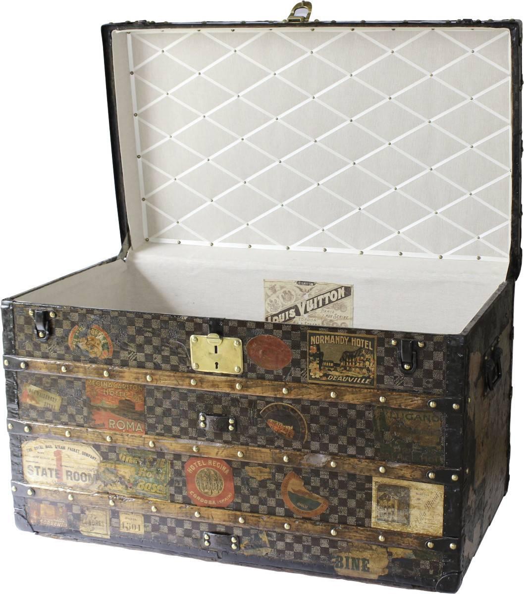 Extremely rare large courier trunk with a collection of vintage hotel stickers from all corners of the globe. Good condition inside and out this will make a statement in any home. Refurbished interior quilting.