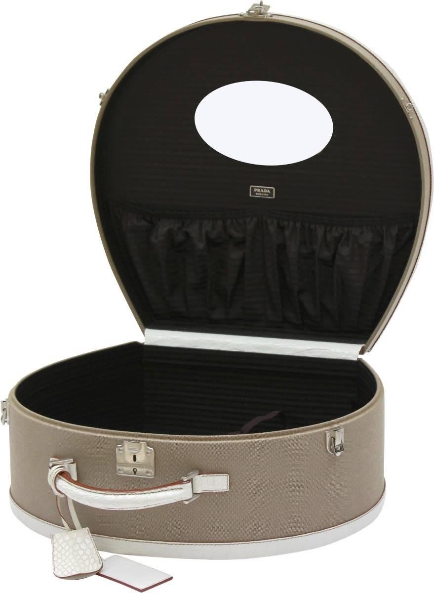 Stunning Prada canvas and crocodile edged hat box. This exquisite hatbox is handcrafted in Milan out of the finest materials available. Finished with white crocodile edging and canvas lining and a mirror inside.