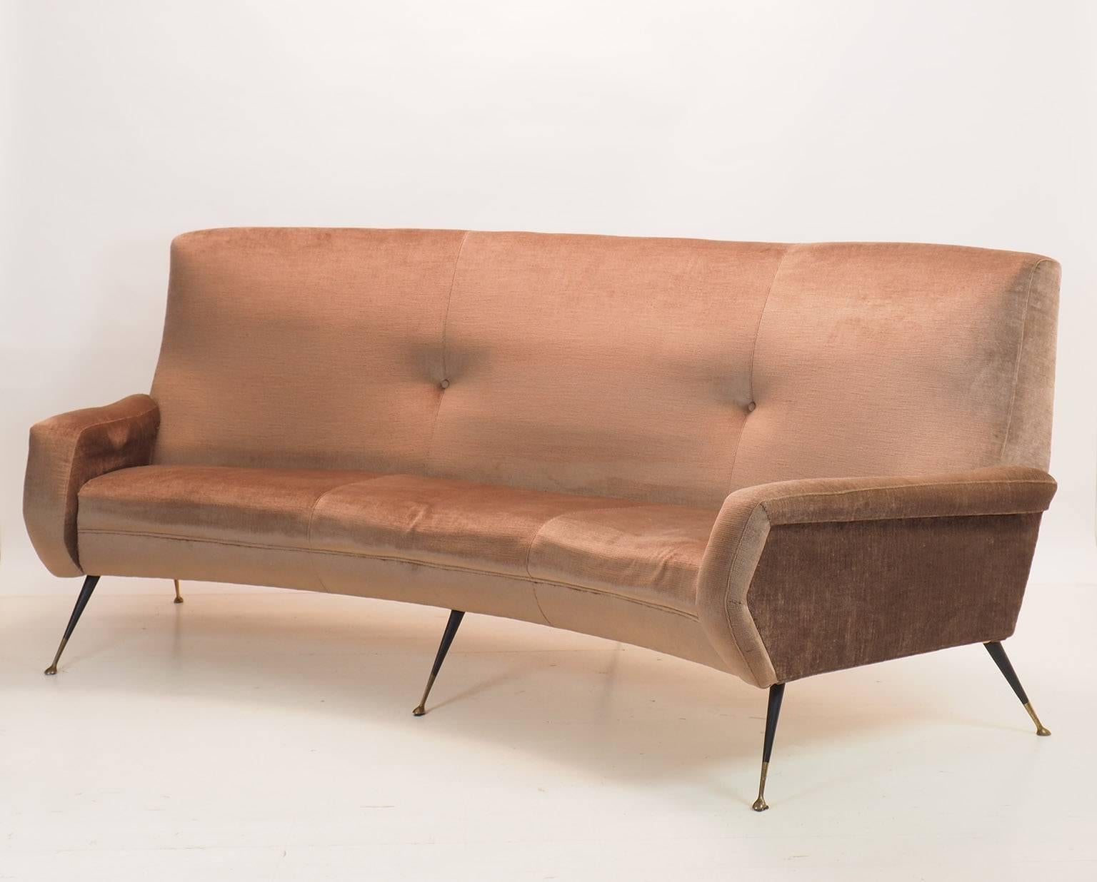 Modern and stylish,
Italian, three-seats curved sofa from Milano, 1950s.
Designer; Gigi Radice, manufactured by Minotti Milano.
Original light brown velvet upholstery in good condition.
Black lacquered metal legs with nice brass feet.
We can