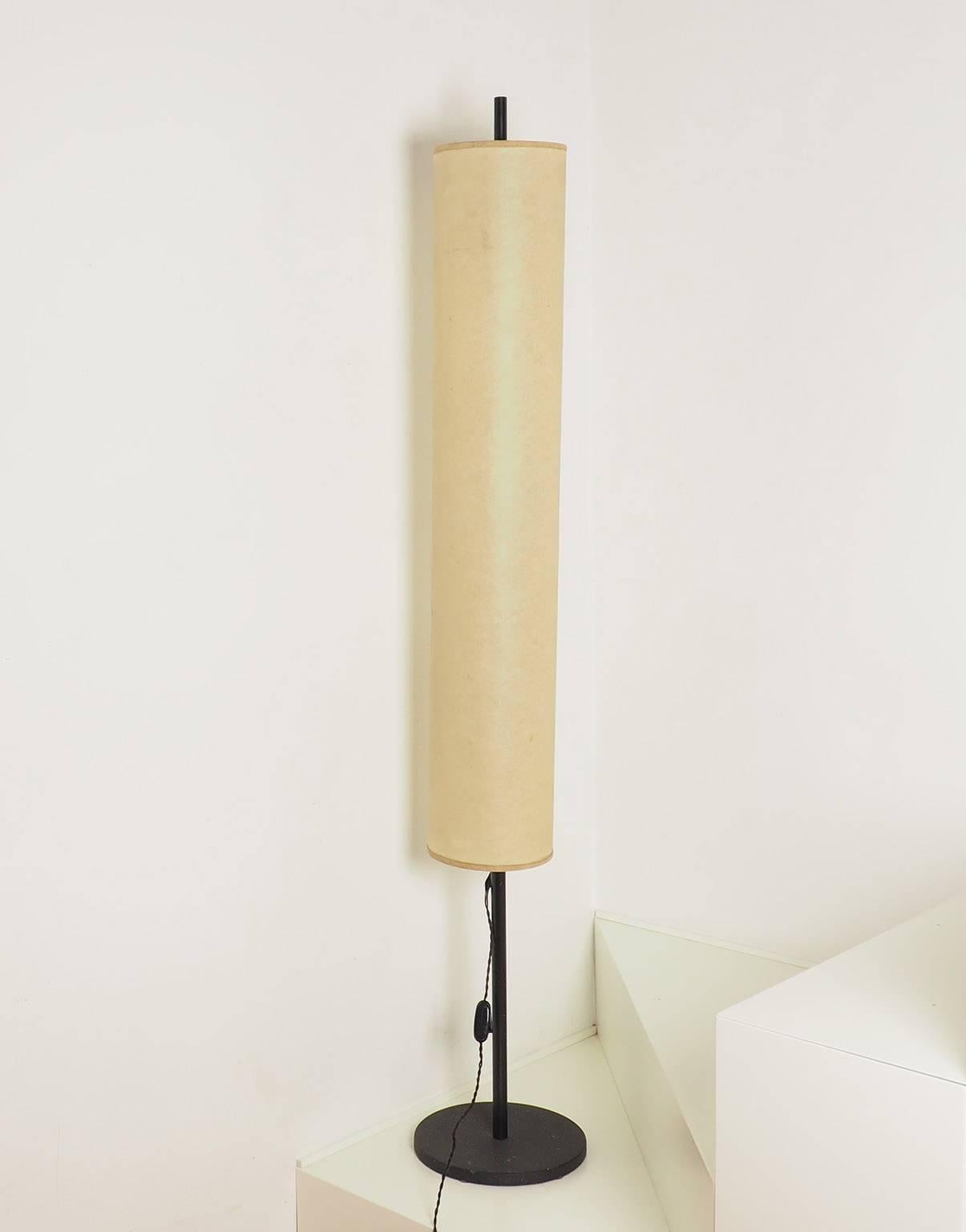 Slim and long-limbed shape. High quality together a simple and well proportioned design, for this lamp in the Arteluce style. Black Craquele' cast iron basement with black lacquered brass structure and its original parchment paper shade.