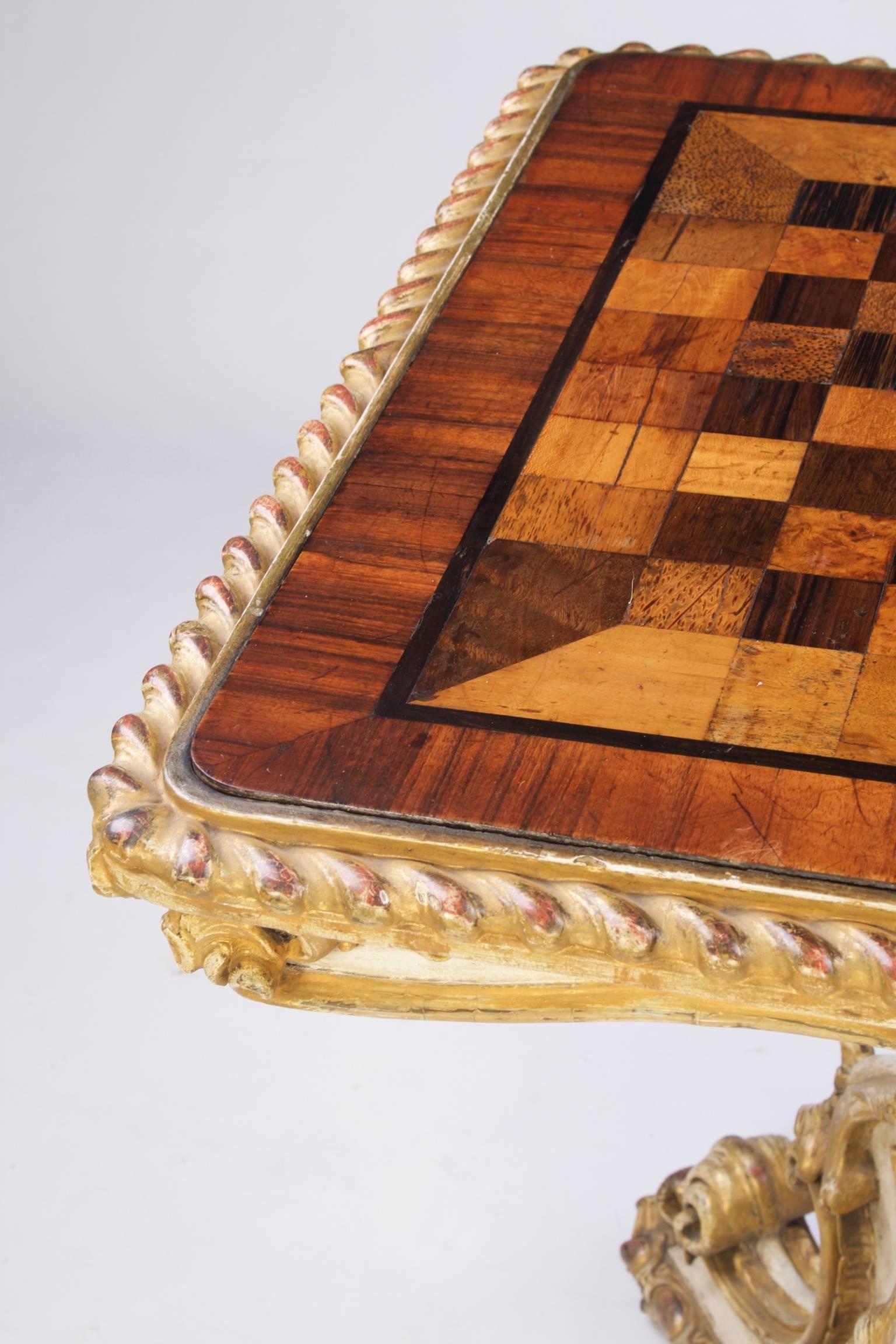A fine quality specimen wood games table veneered with exotic timbers including East Indian satinwood, amboyna, palmwood, purplewood, and tigerwood. All inset within ebony banding and two inch South American rosewood cross banding and surrounded by