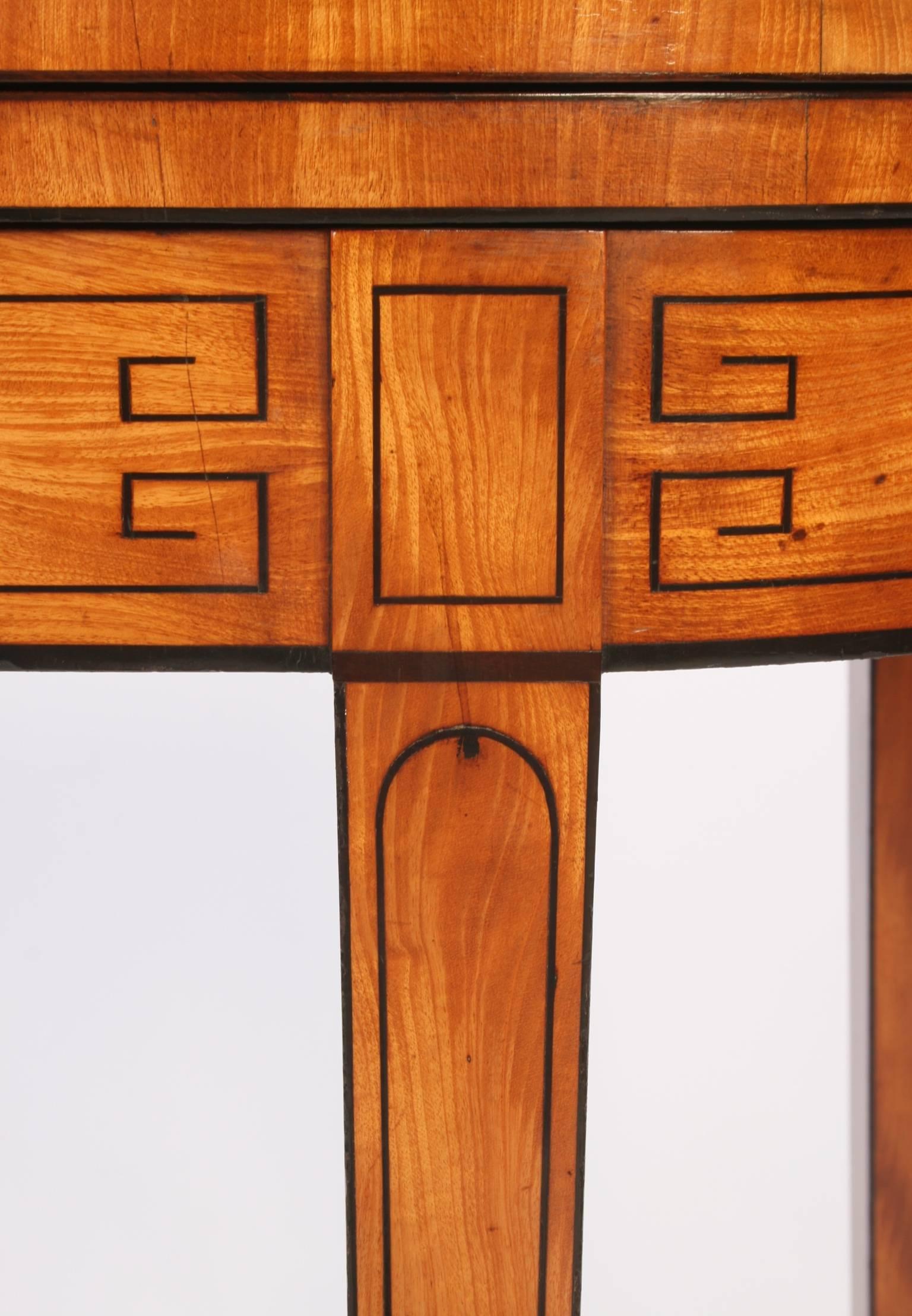 A very impressive late eighteenth century satinwood card table of small proportions and in excellent condition. Broadly cross banded in rosewood and lined with ebony and boxwood along the top. This piece has geometric ebony stringing along the