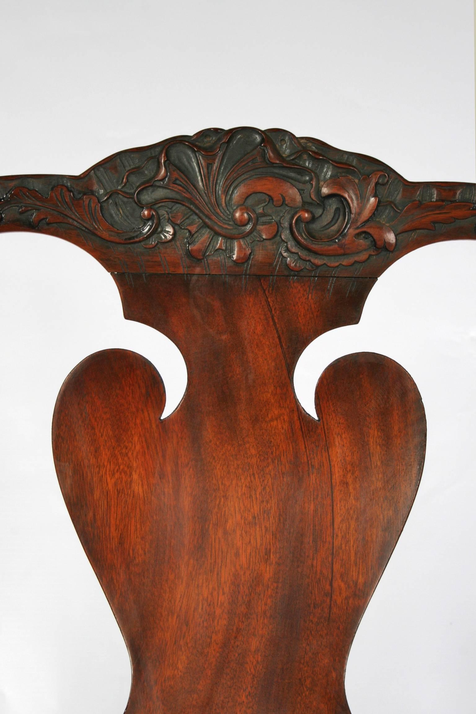 A very attractive set  of mahogany dining chairs consisting of two arm chairs and six singles. Having carved leaf cresting above a vase shaped back splat. Raised on two rear splay legs and front cabriole legs, having scallop shell carving with